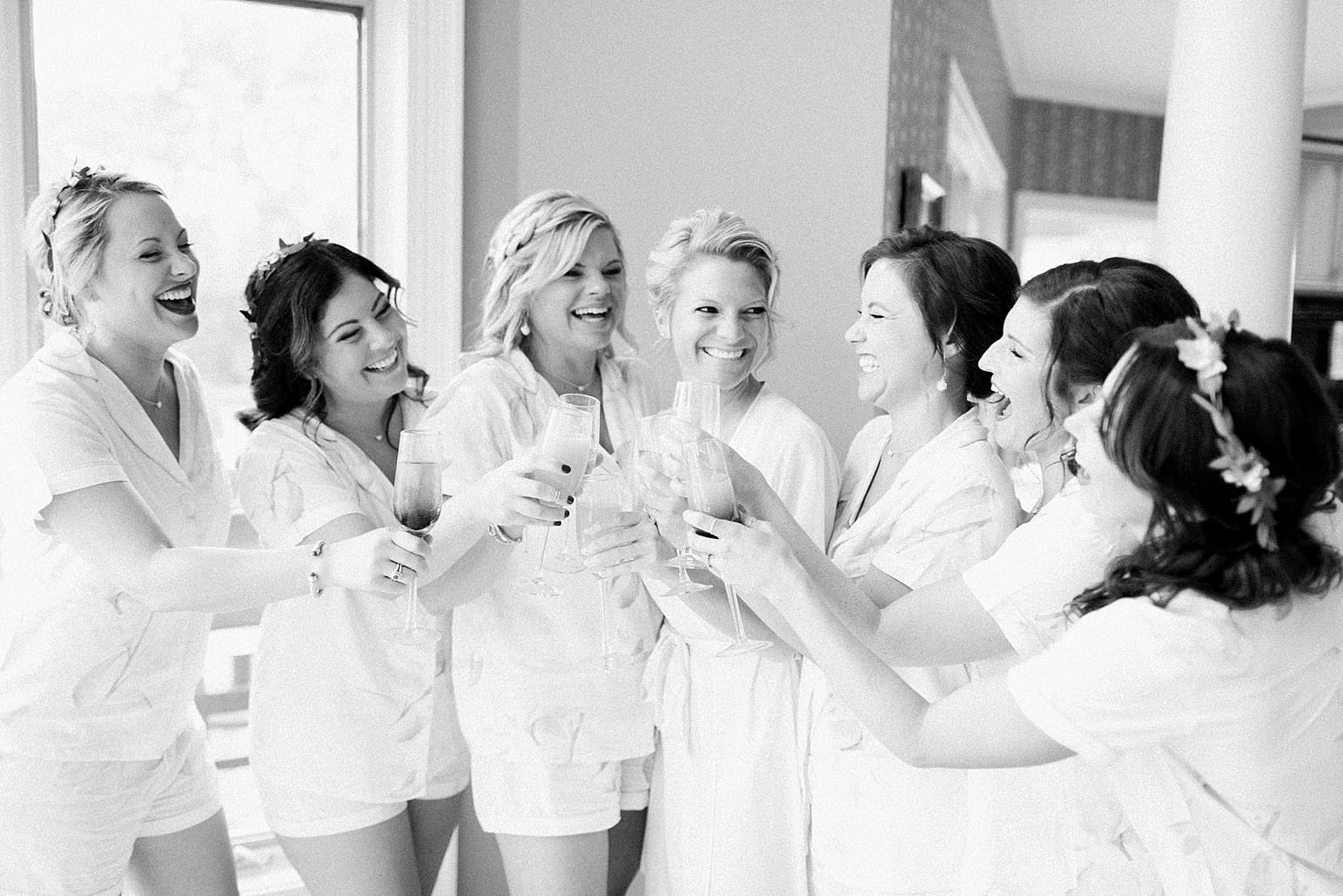 Arielle Peters Photography | Bride and bridesmaids getting ready in pajamas on wedding day at Joseph Decuis Farm in Roanoke, Indiana.