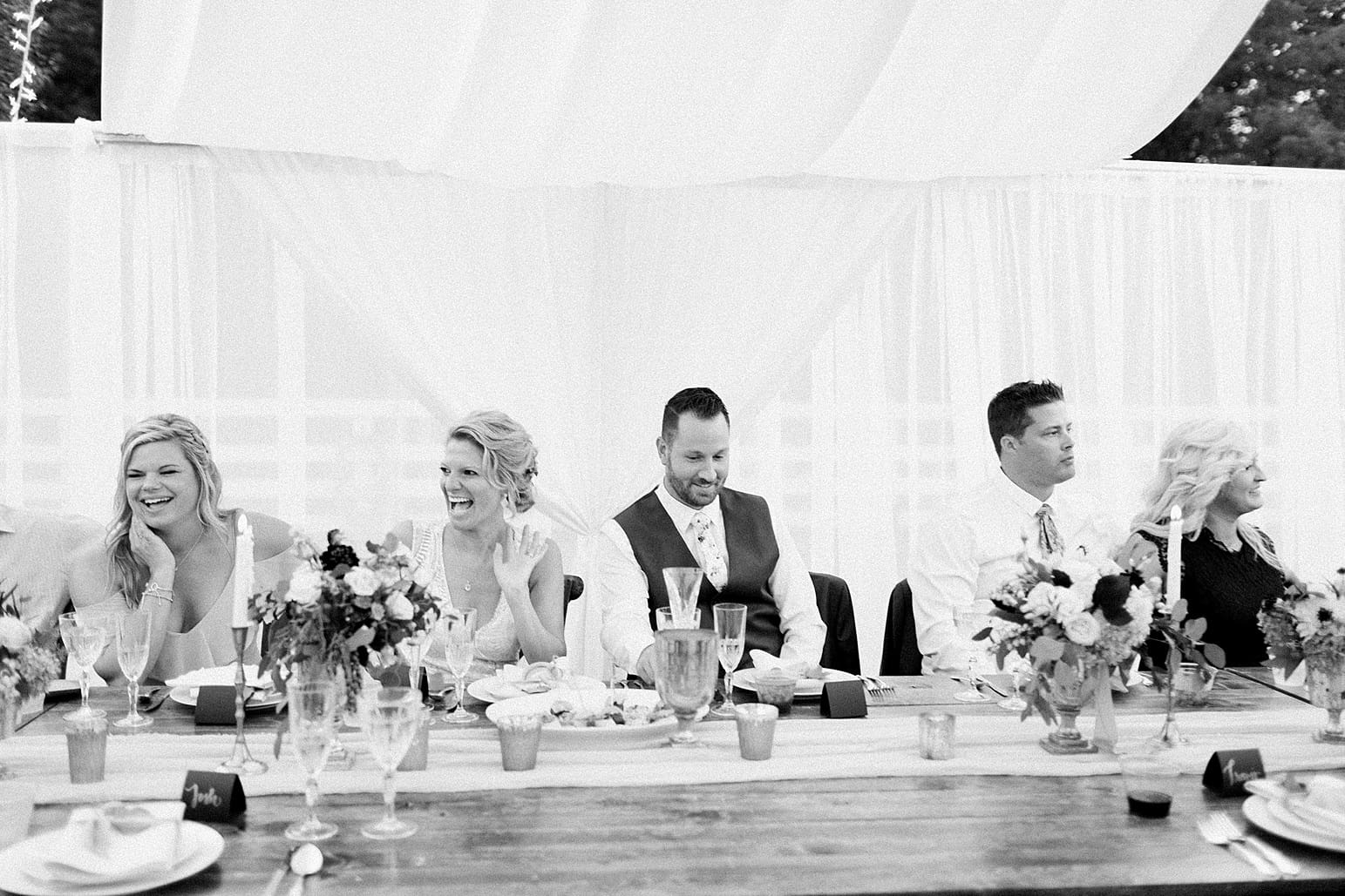 Arielle Peters Photography | Bride and groom laughing at wedding reception on wedding day at Joseph Decuis Farm in Roanoke, Indiana.