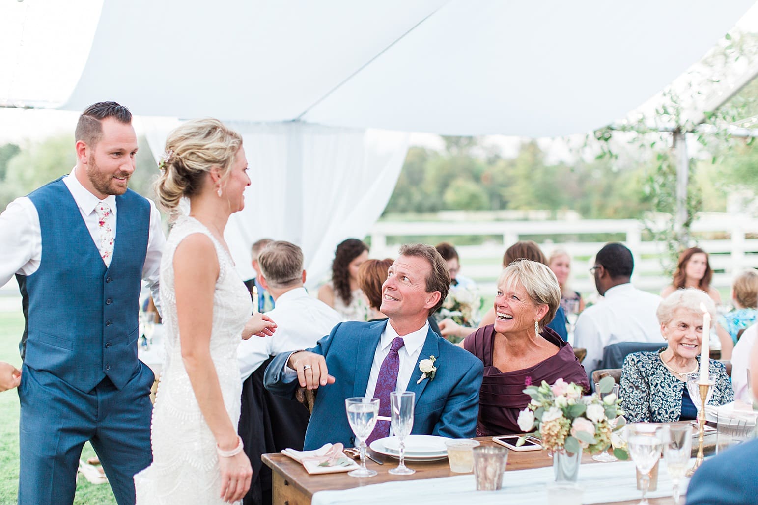Arielle Peters Photography | Wedding guests toasting at outdoor wedding reception on wedding day at Joseph Decuis Farm in Roanoke, Indiana.