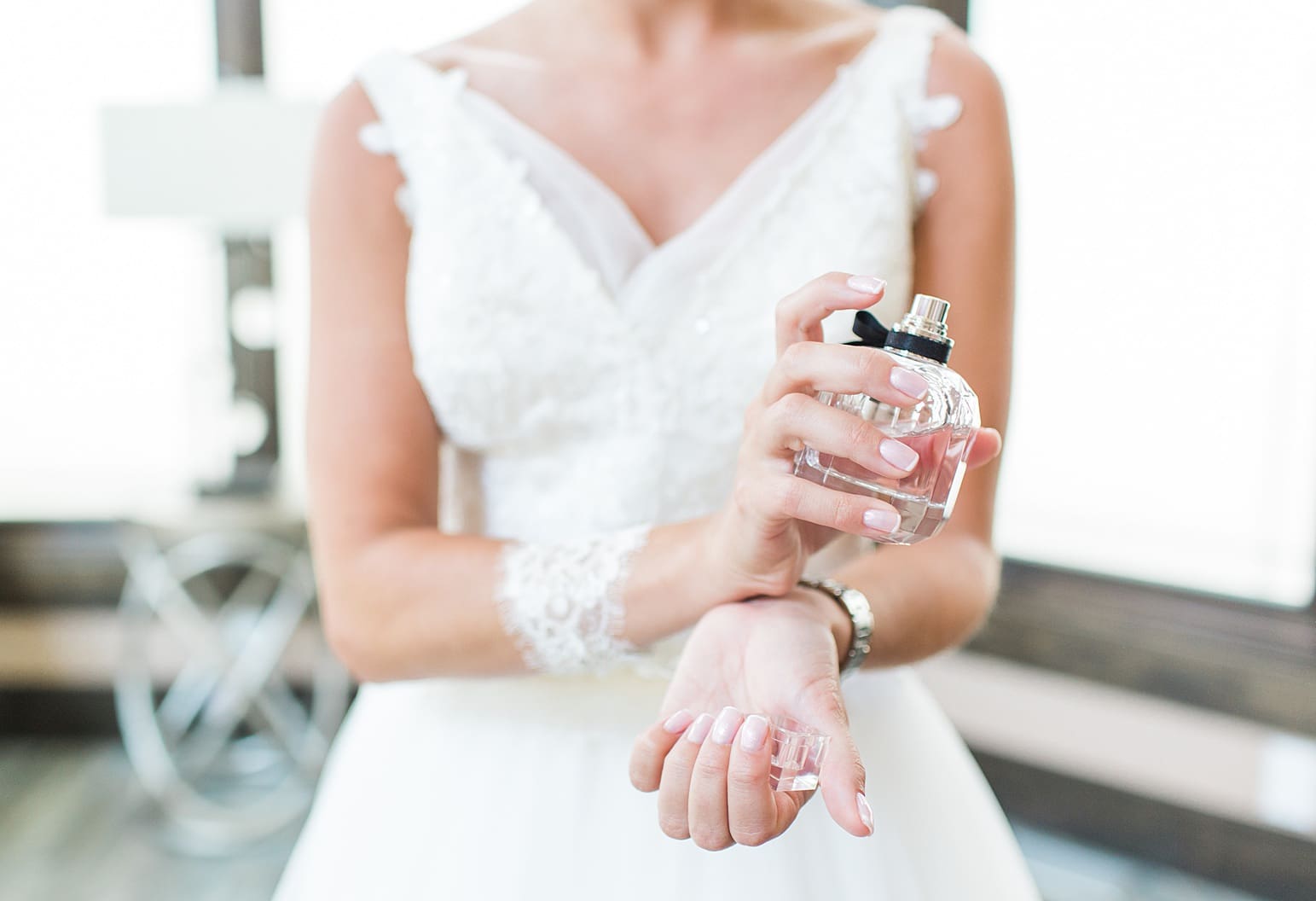 Arielle Peters Photography | Bride putting on perfume on wedding day at The Pavilion at Sandy Pines in Demotte, Indiana.