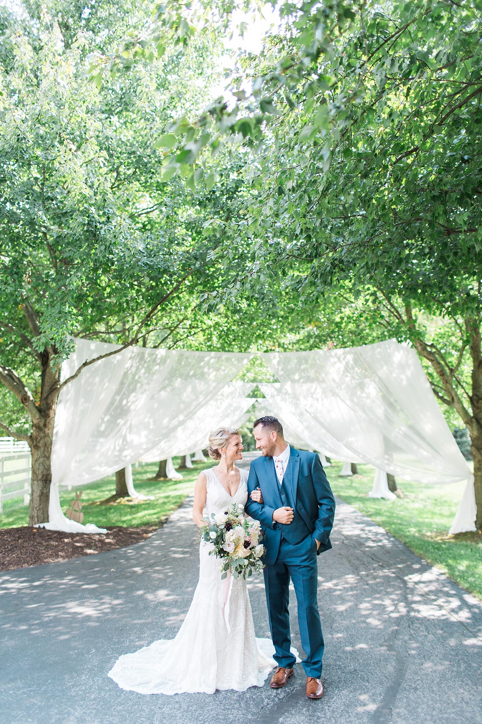 Arielle Peters Photography | Bride and groom standing on street on wedding day at Joseph Decuis Farm in Roanoke, Indiana.