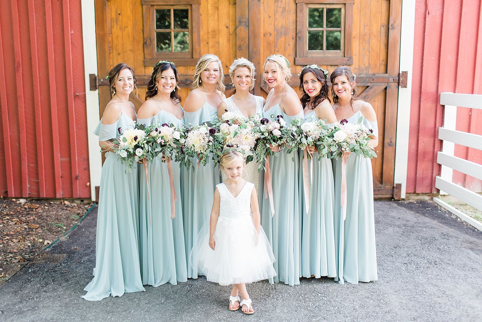 Arielle Peters Photography | Bride and bridesmaids standing in front of wooden barn door on wedding day at Joseph Decuis Farm in Roanoke, Indiana.