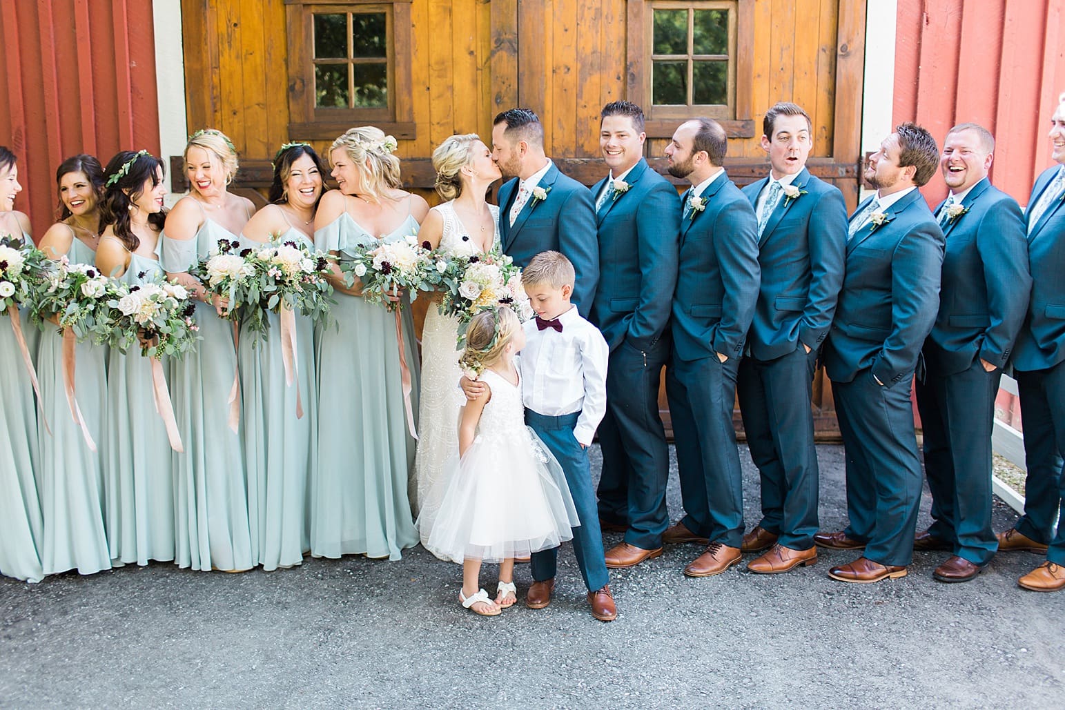 Arielle Peters Photography | Wedding party standing in front of wood barn doors on wedding day at Joseph Decuis Farm in Roanoke, Indiana.