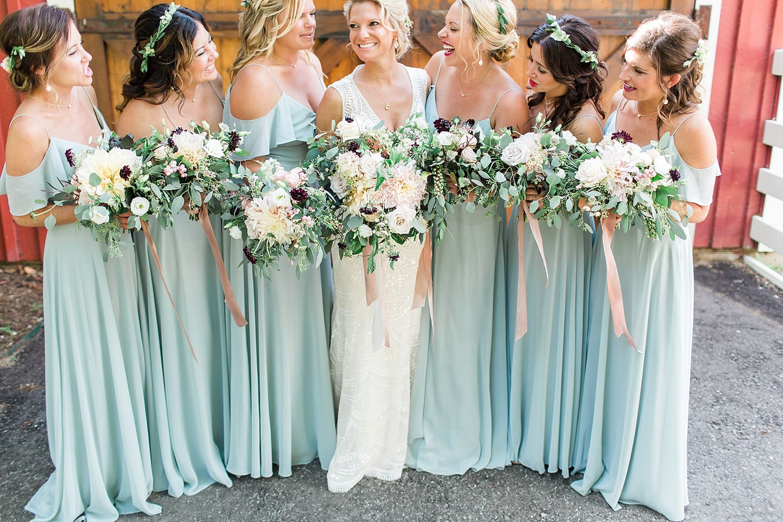 Arielle Peters Photography | Bride and bridesmaids in front of wooden barn door on wedding day at Joseph Decuis Farm in Roanoke, Indiana.