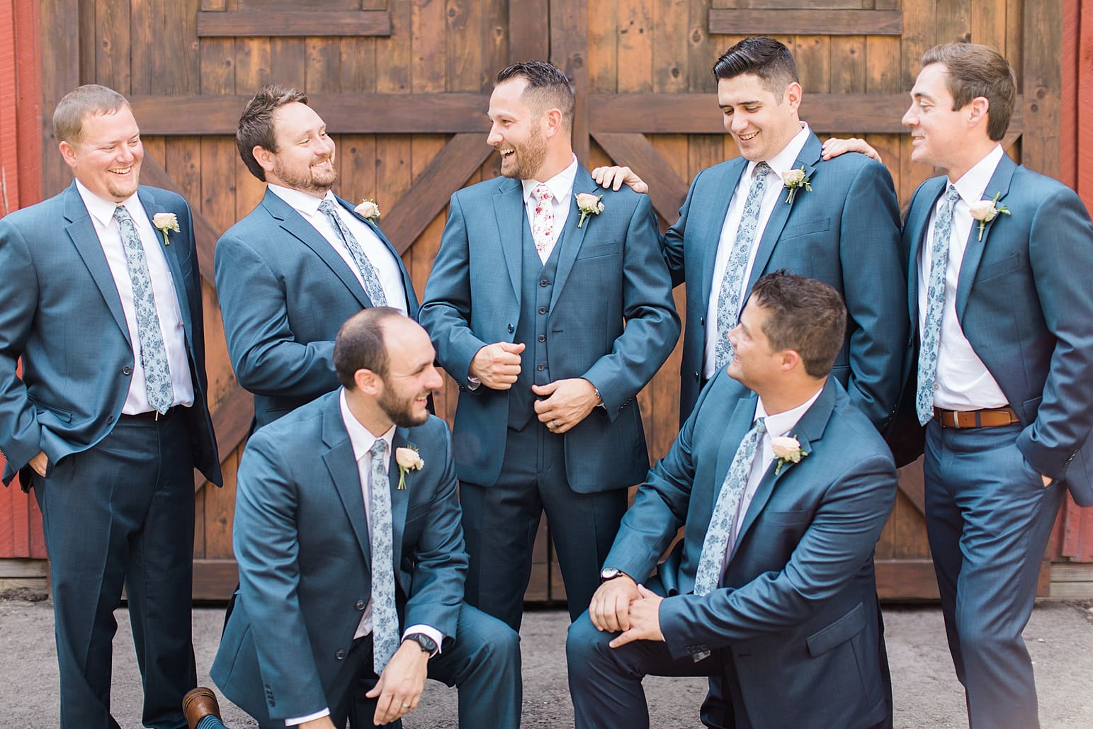Arielle Peters Photography | Groom and groomsmen in front of wooden barn door on wedding day at Joseph Decuis Farm in Roanoke, Indiana.