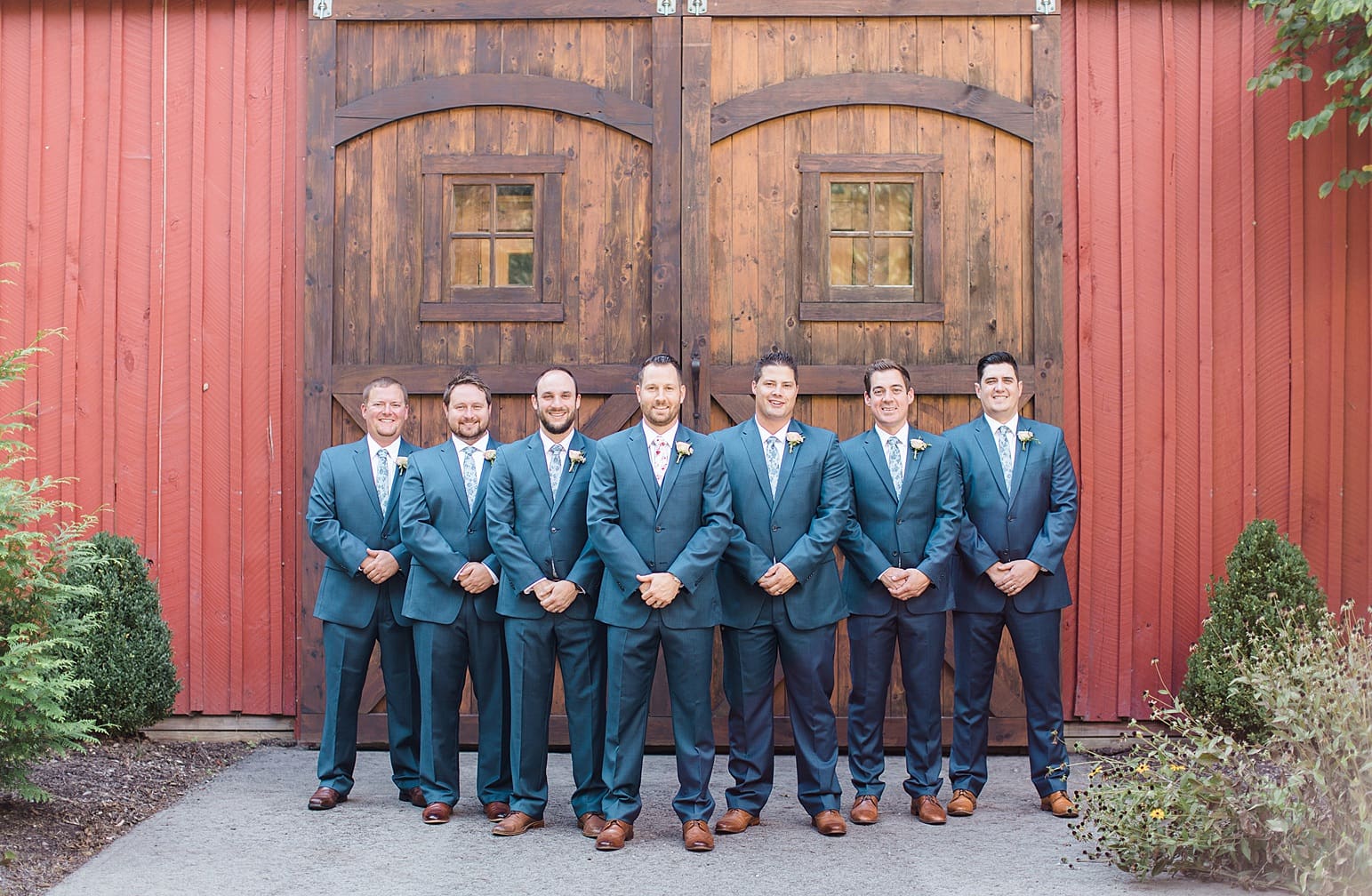Arielle Peters Photography | Bride and groom in front of wooden barn door on wedding day at Joseph Decuis Farm in Roanoke, Indiana.