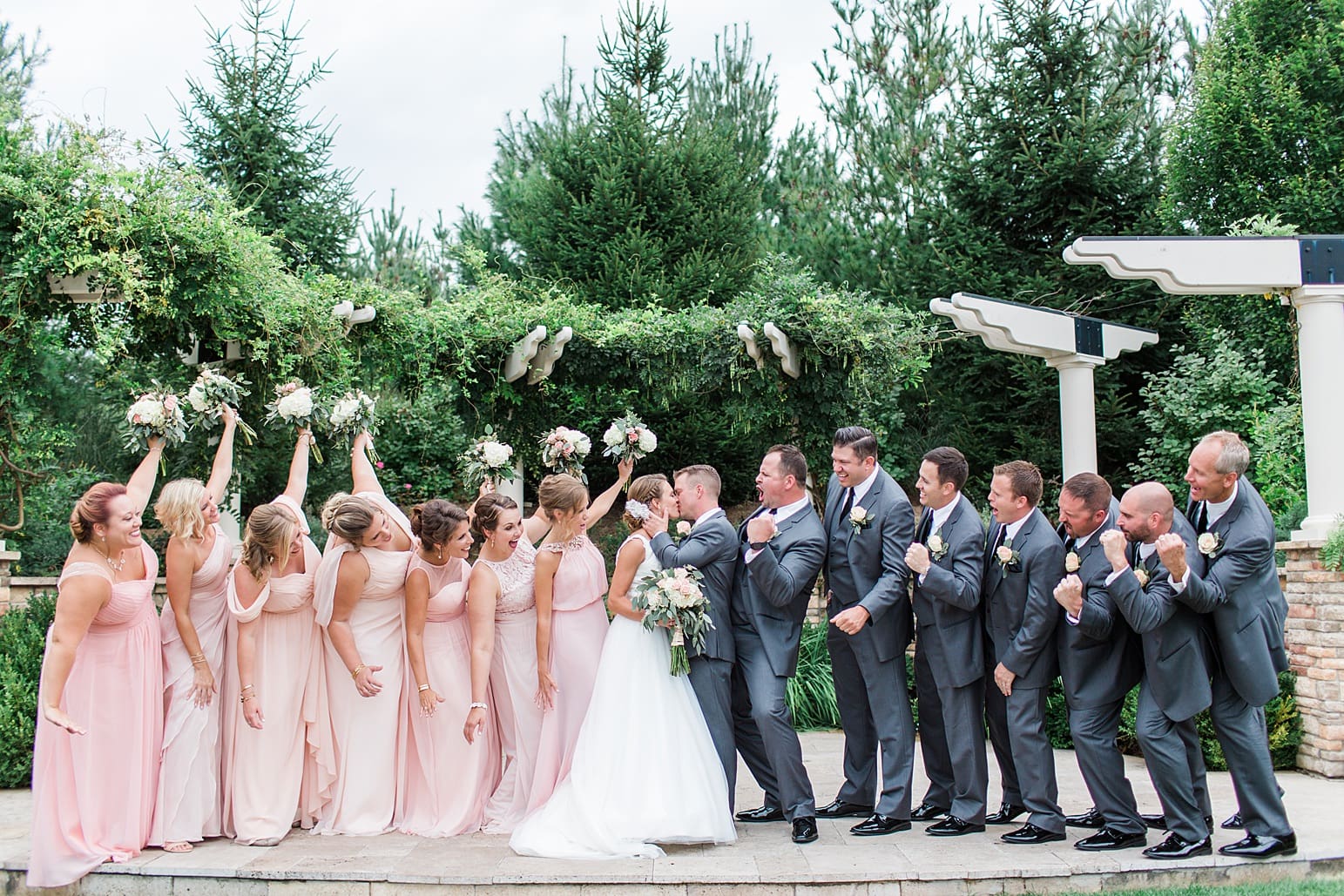 Arielle Peters Photography | Wedding party cheering under pavilion on wedding day at The Pavilion at Sandy Pines in Demotte, Indiana.