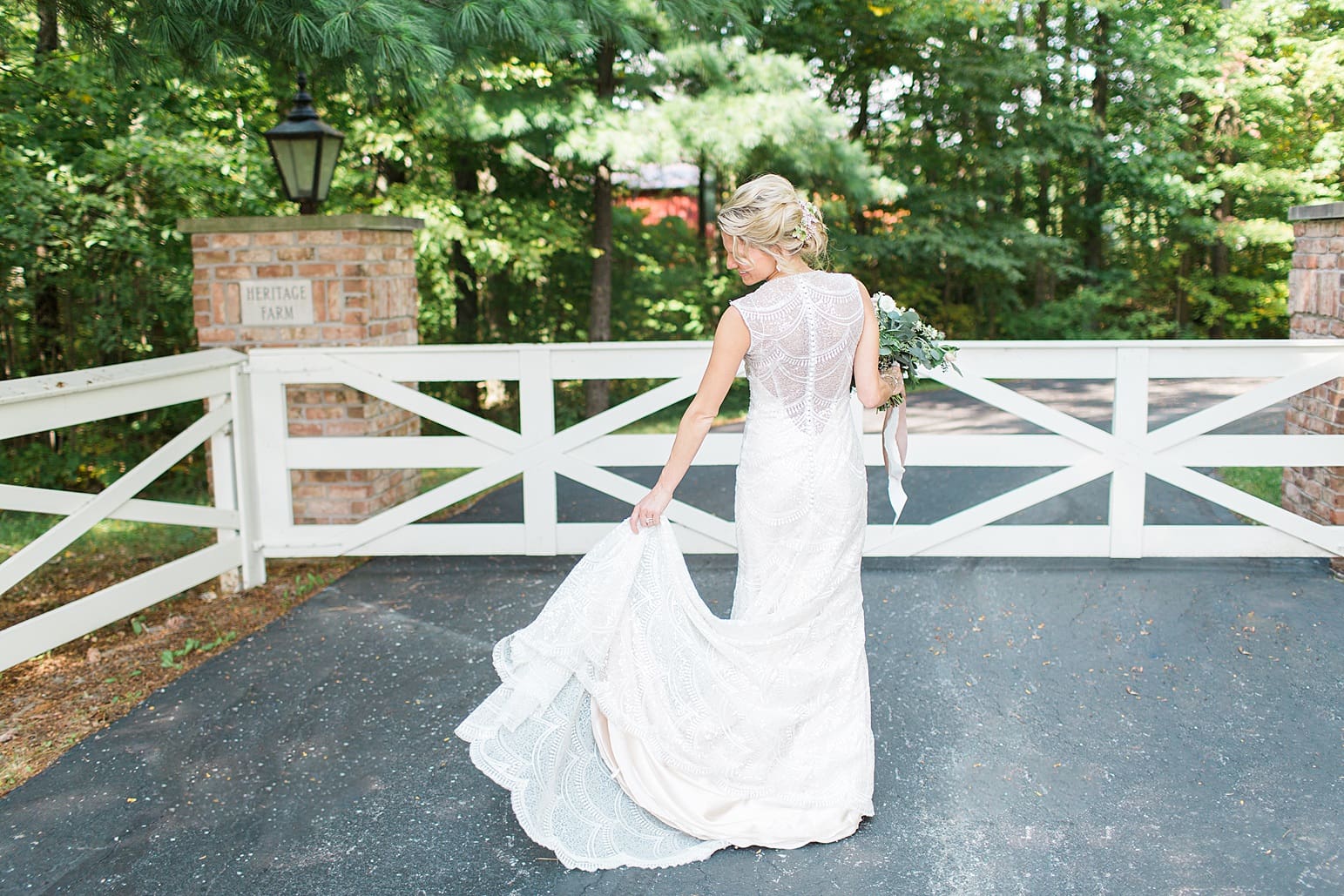 Arielle Peters Photography | Bride in front of white fence on wedding day at Joseph Decuis Farm in Roanoke, Indiana.