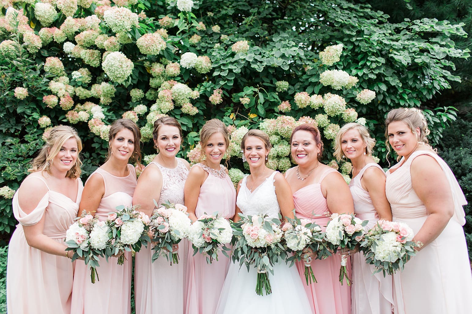 Arielle Peters Photography | Bride and bridesmaids next to hydrangeas on wedding day at The Pavilion at Sandy Pines in Demotte, Indiana.