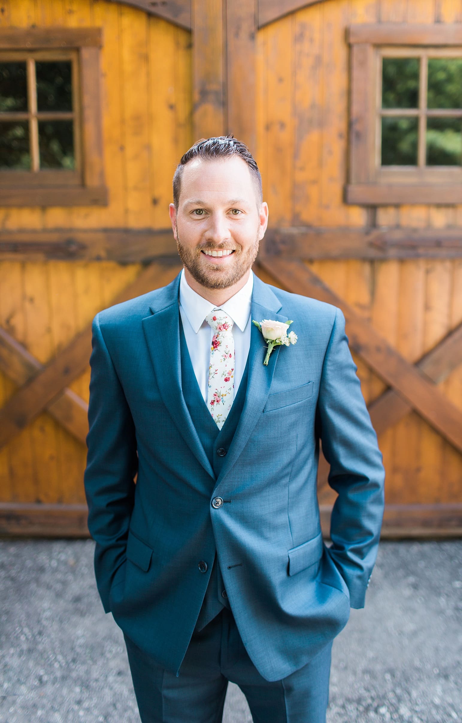 Arielle Peters Photography | Groom in front of wooden barn door on wedding day at Joseph Decuis Farm in Roanoke, Indiana.