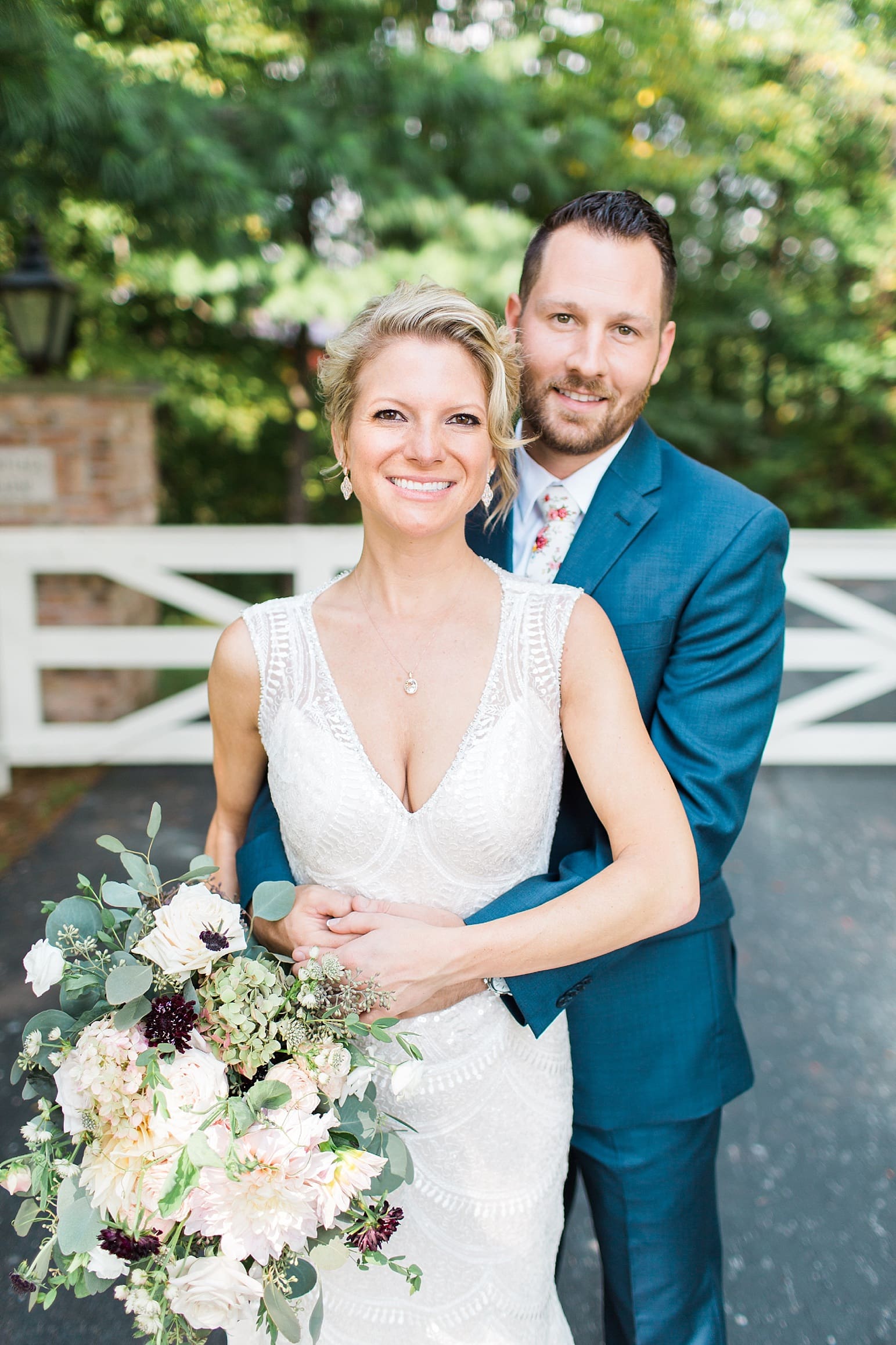 Arielle Peters Photography | Bride and groom in front of white fence on wedding day at Joseph Decuis Farm in Roanoke, Indiana.
