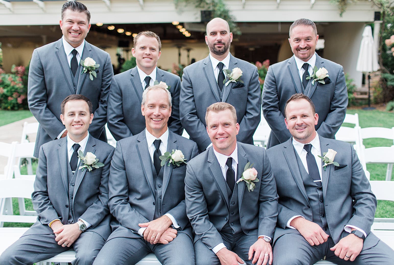 Arielle Peters Photography | Groom and groomsmen sitting on benches on wedding day at The Pavilion at Sandy Pines in Demotte, Indiana.