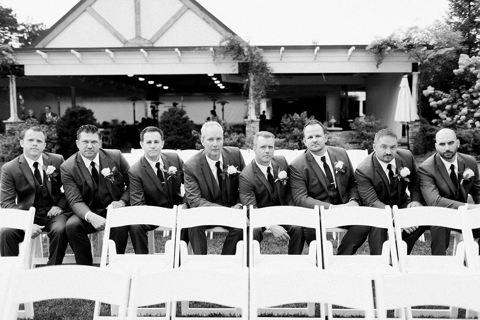 Arielle Peters Photography | Groom and groomsmen sitting outside on wedding day at The Pavilion at Sandy Pines in Demotte, Indiana.