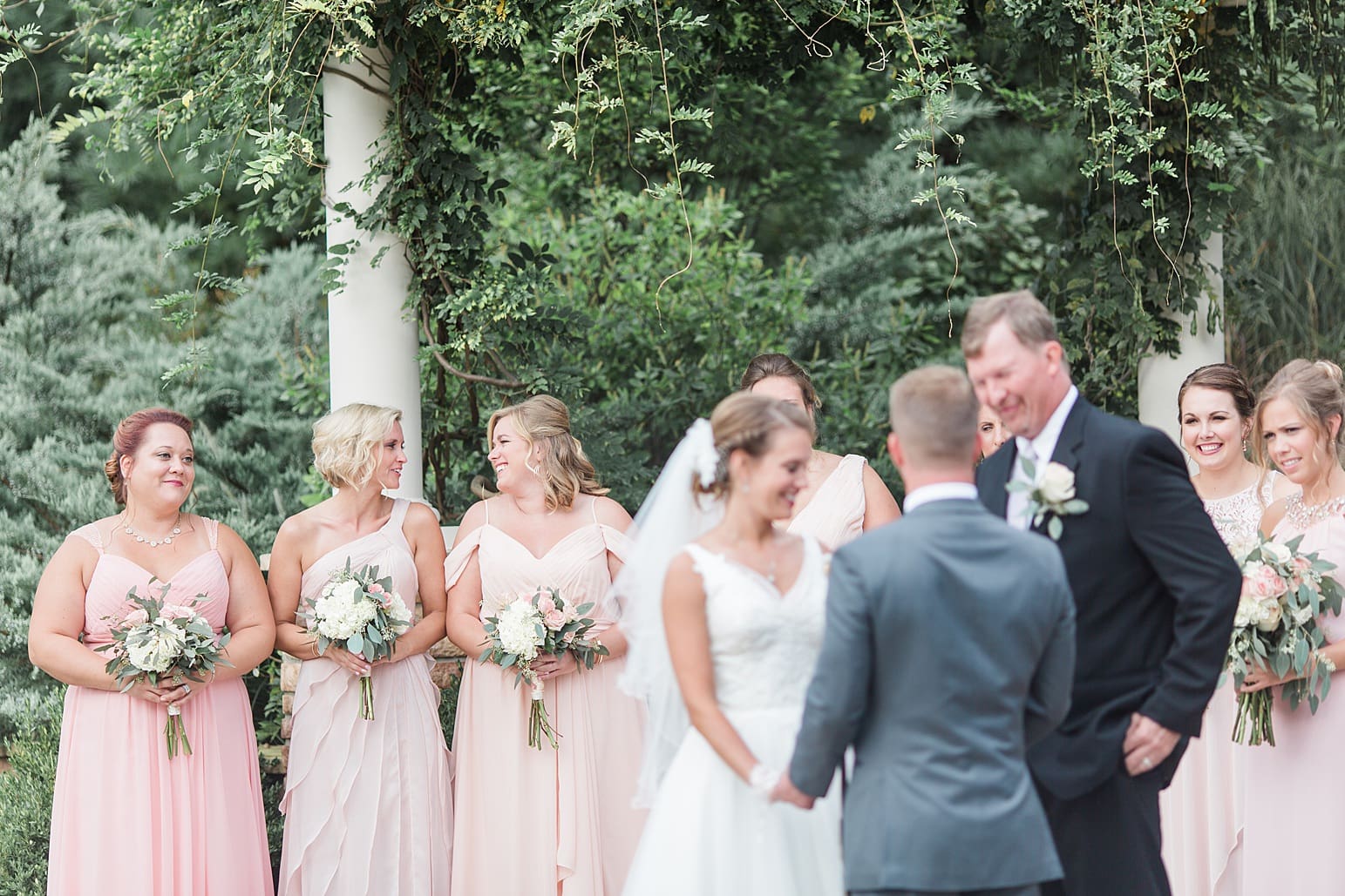 Arielle Peters Photography | Bride and groom holding hands at the alter on wedding day at The Pavilion at Sandy Pines in Demotte, Indiana.