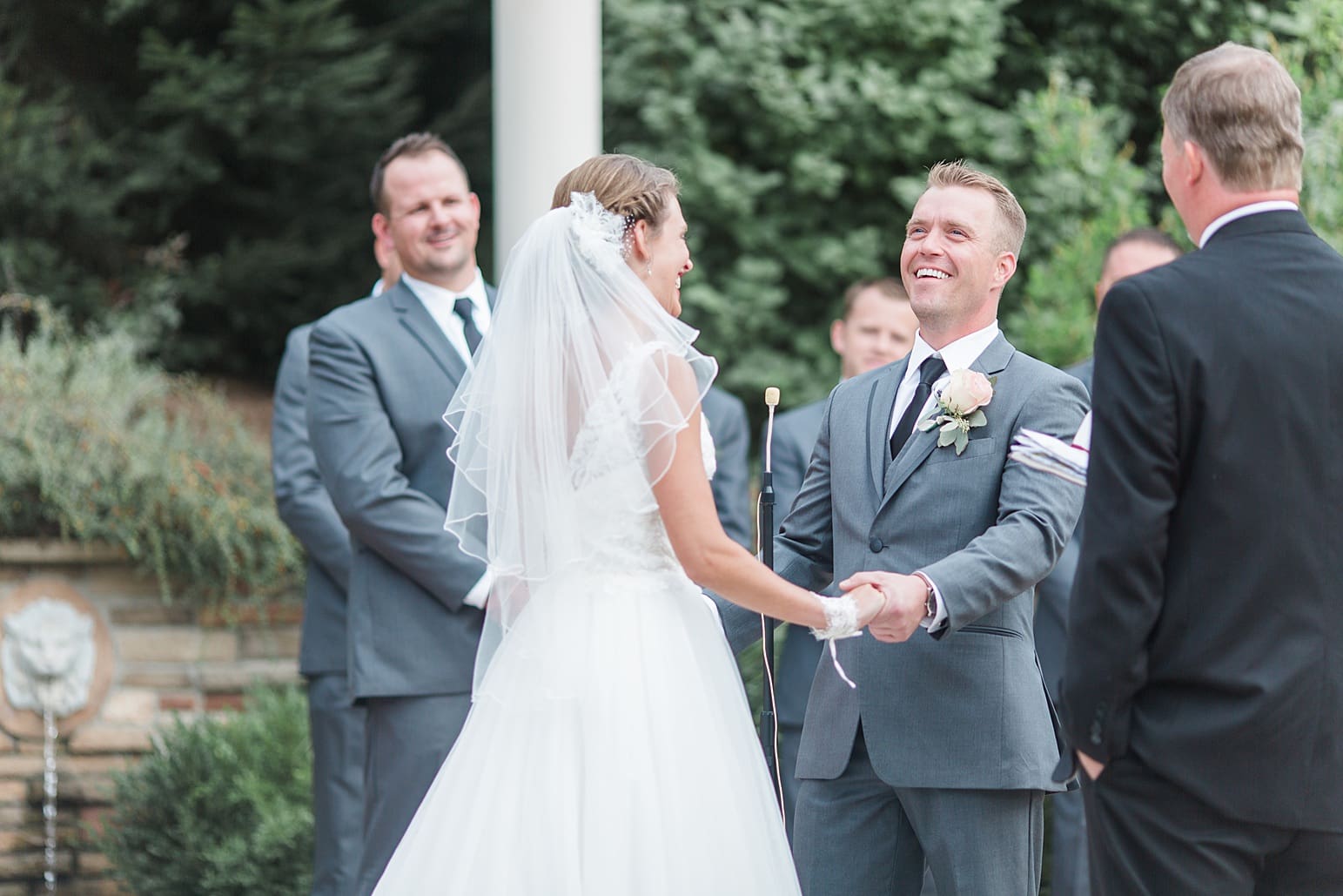 Arielle Peters Photography | Bride and groom holding hands at the alter on wedding day at The Pavilion at Sandy Pines in Demotte, Indiana.