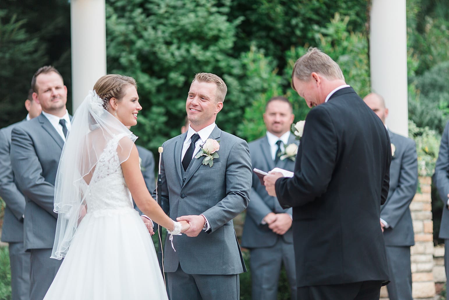 Arielle Peters Photography | Bride and groom holding hands at the alter on wedding day at The Pavilion at Sandy Pines in Demotte, Indiana.