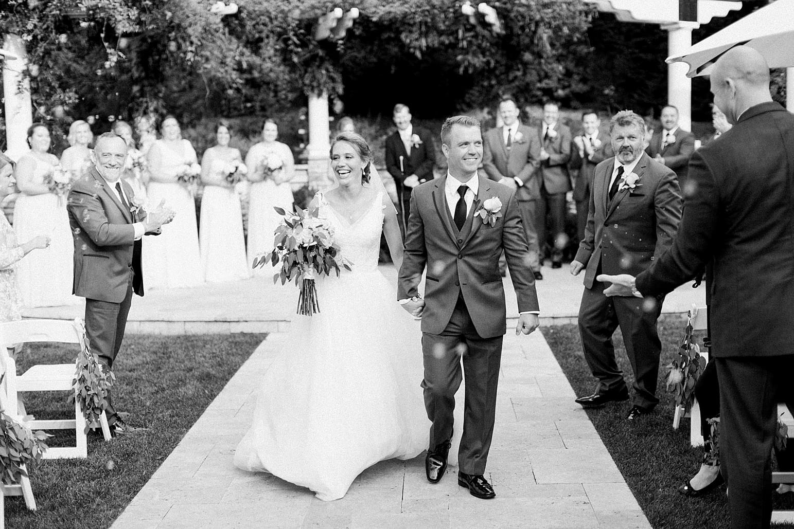 Arielle Peters Photography | Bride and groom walking down the aisle on wedding day at The Pavilion at Sandy Pines in Demotte, Indiana.
