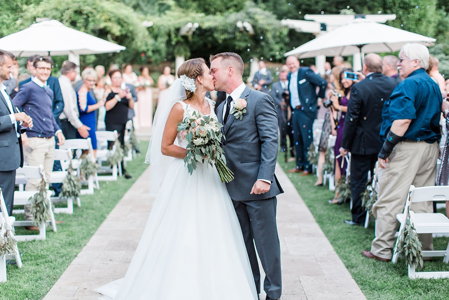 Arielle Peters Photography | Bride and groom kissing in the aisle on wedding day at The Pavilion at Sandy Pines in Demotte, Indiana.