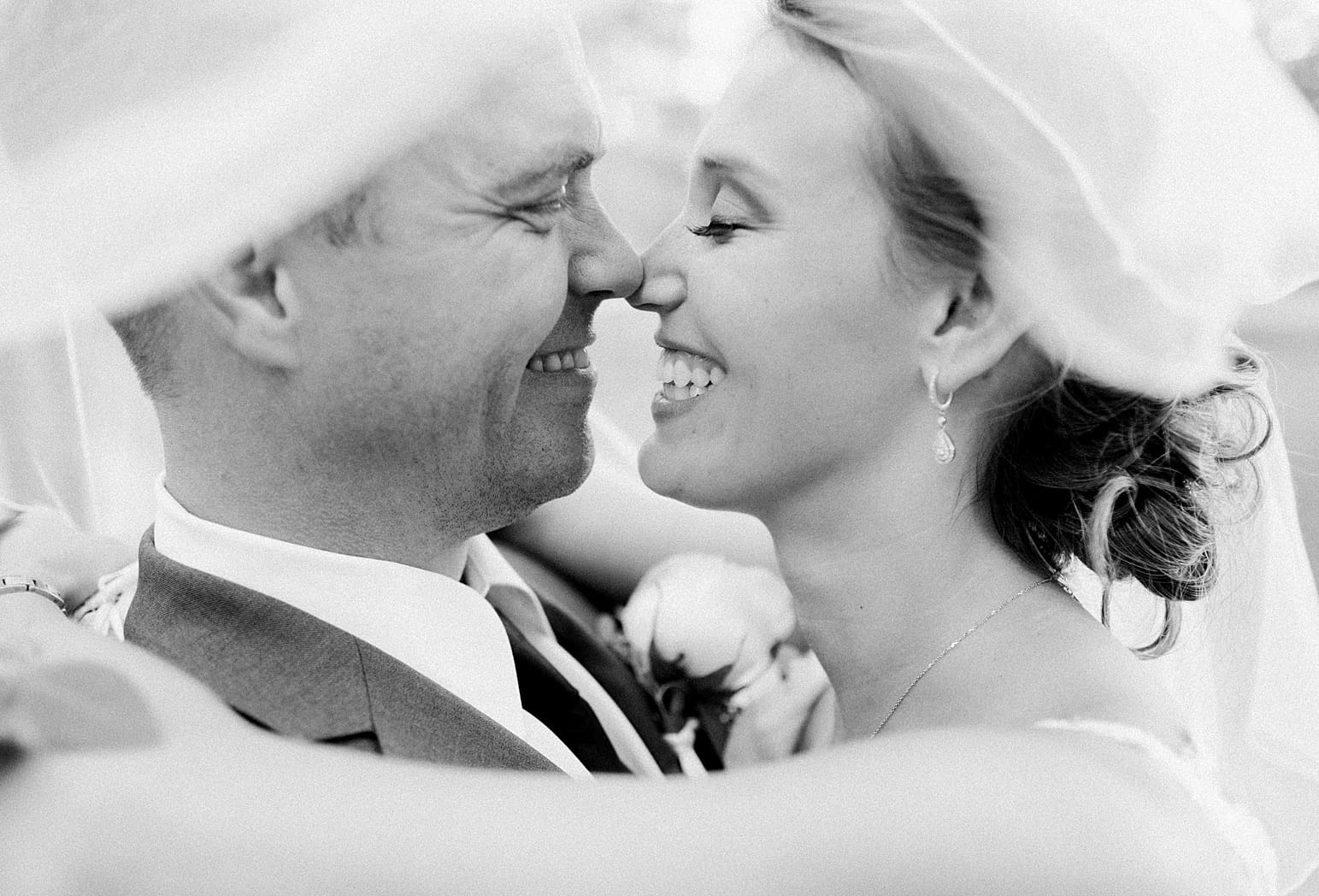 Arielle Peters Photography | Bride and groom kissing under veil on wedding day at The Pavilion at Sandy Pines in Demotte, Indiana.