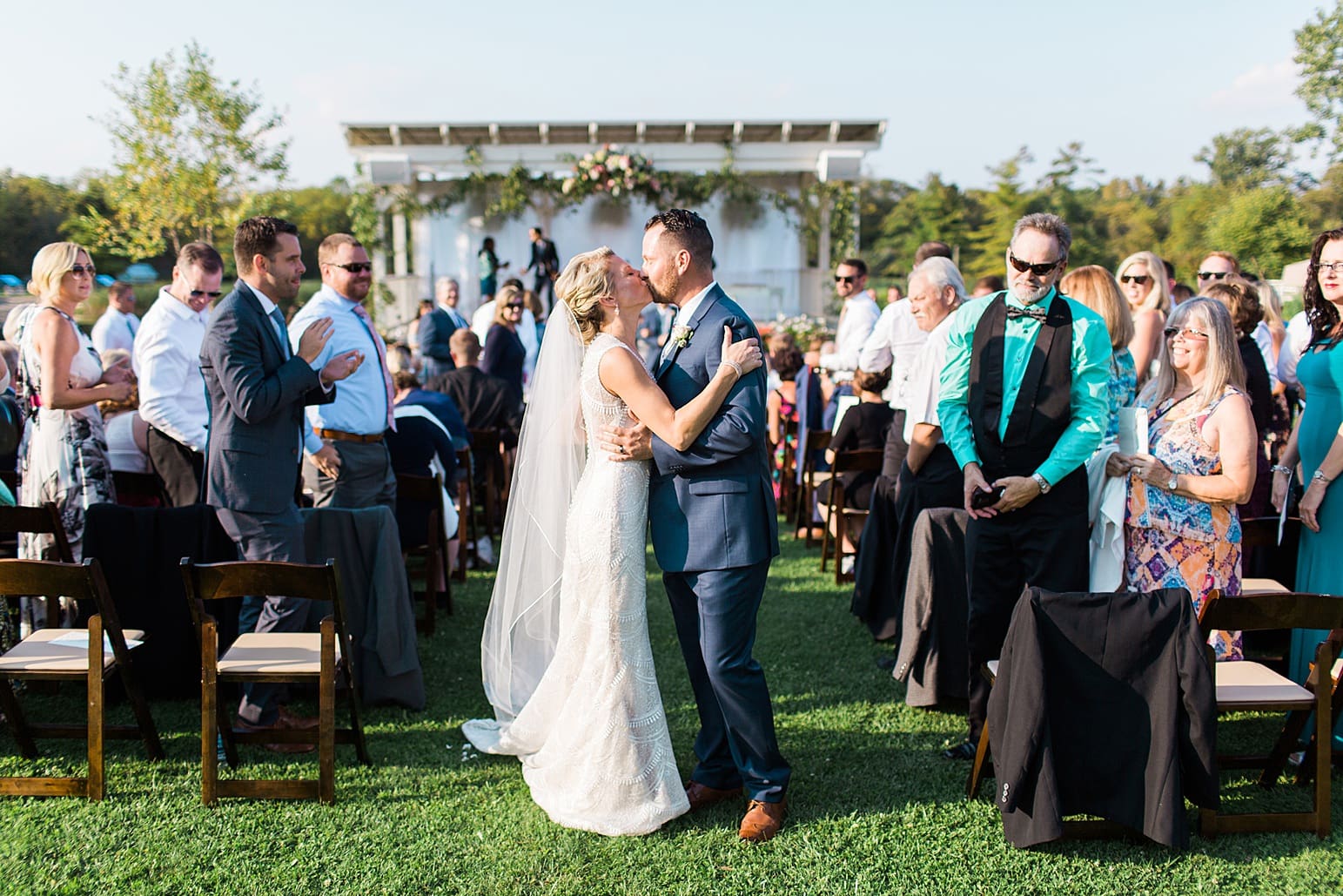 Arielle Peters Photography | Bride and groom kissing in the aisle at outdoor wedding ceremony at Joseph Decuis Farm in Roanoke, Indiana.