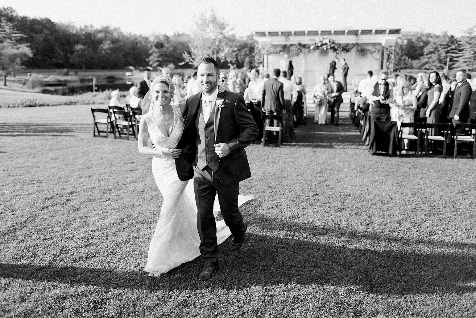 Arielle Peters Photography | Bride and groom walking at outdoor wedding ceremony at Joseph Decuis Farm in Roanoke, Indiana.