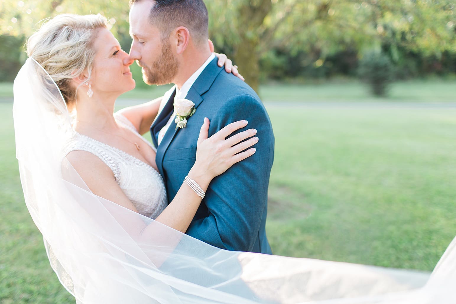 Arielle Peters Photography | Bride and groom almost kissing next to pond and willow tree on wedding day at Joseph Decuis Farm in Roanoke, Indiana.