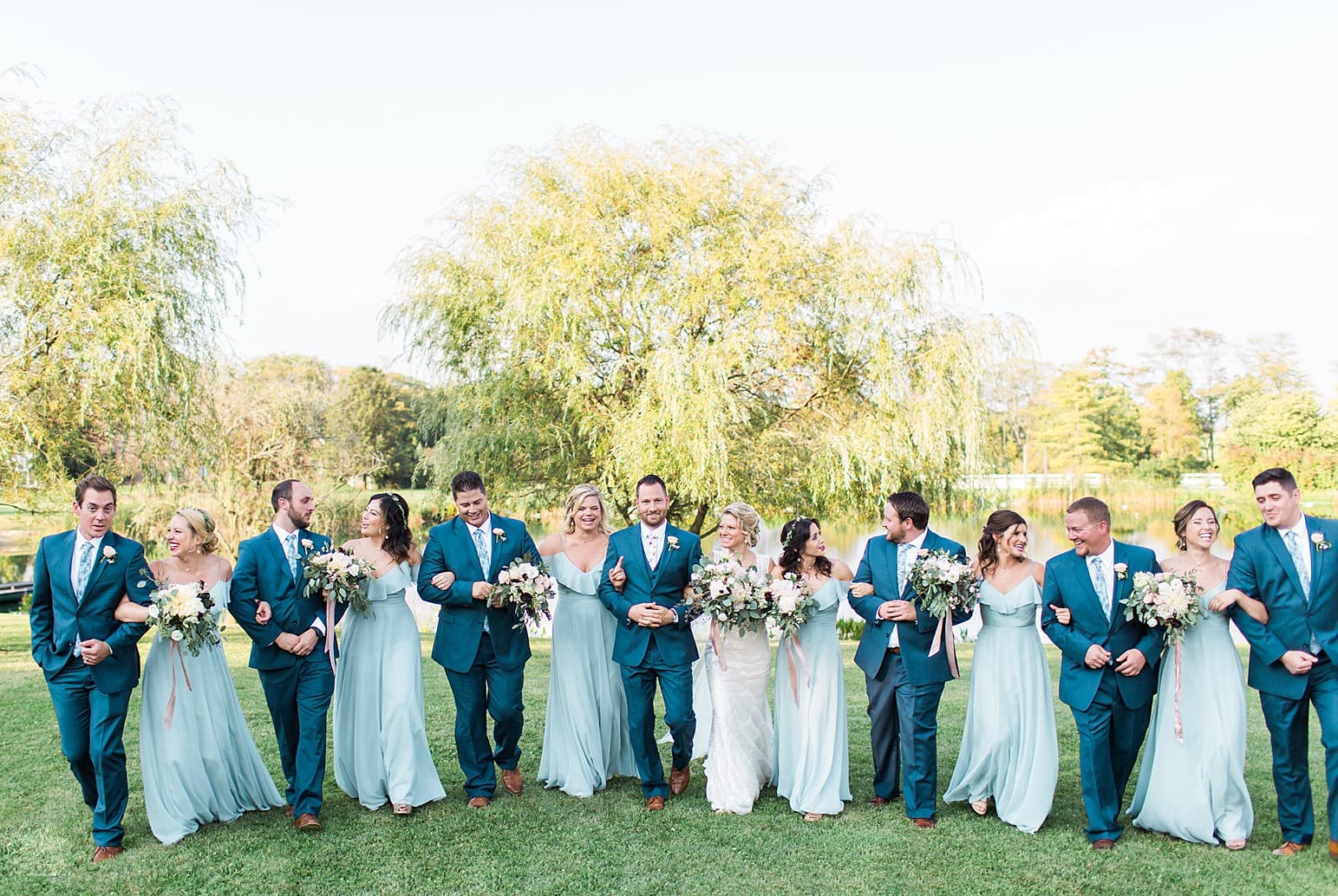 Arielle Peters Photography | Wedding party walking next to pond and willow tree on wedding day at Joseph Decuis Farm in Roanoke, Indiana.