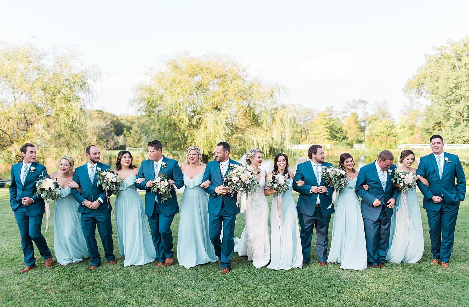 Arielle Peters Photography | Wedding party walking next to pond on wedding day at Joseph Decuis Farm in Roanoke, Indiana.