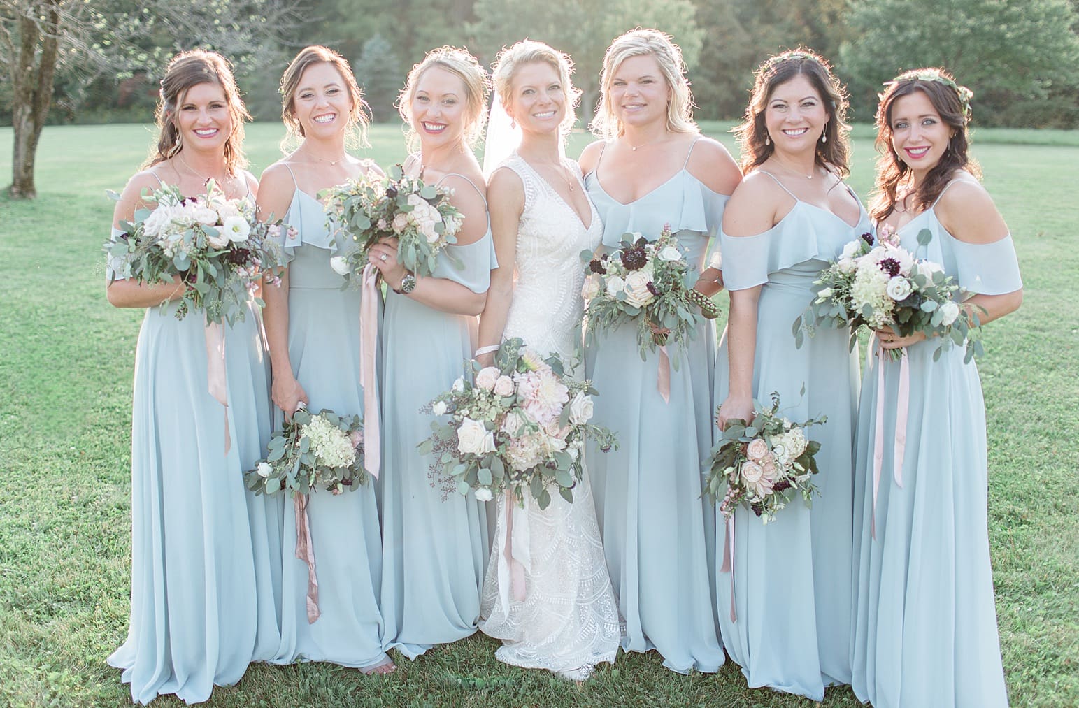 Arielle Peters Photography | Bride and bridesmaids in open field next to pond on wedding day at Joseph Decuis Farm in Roanoke, Indiana.