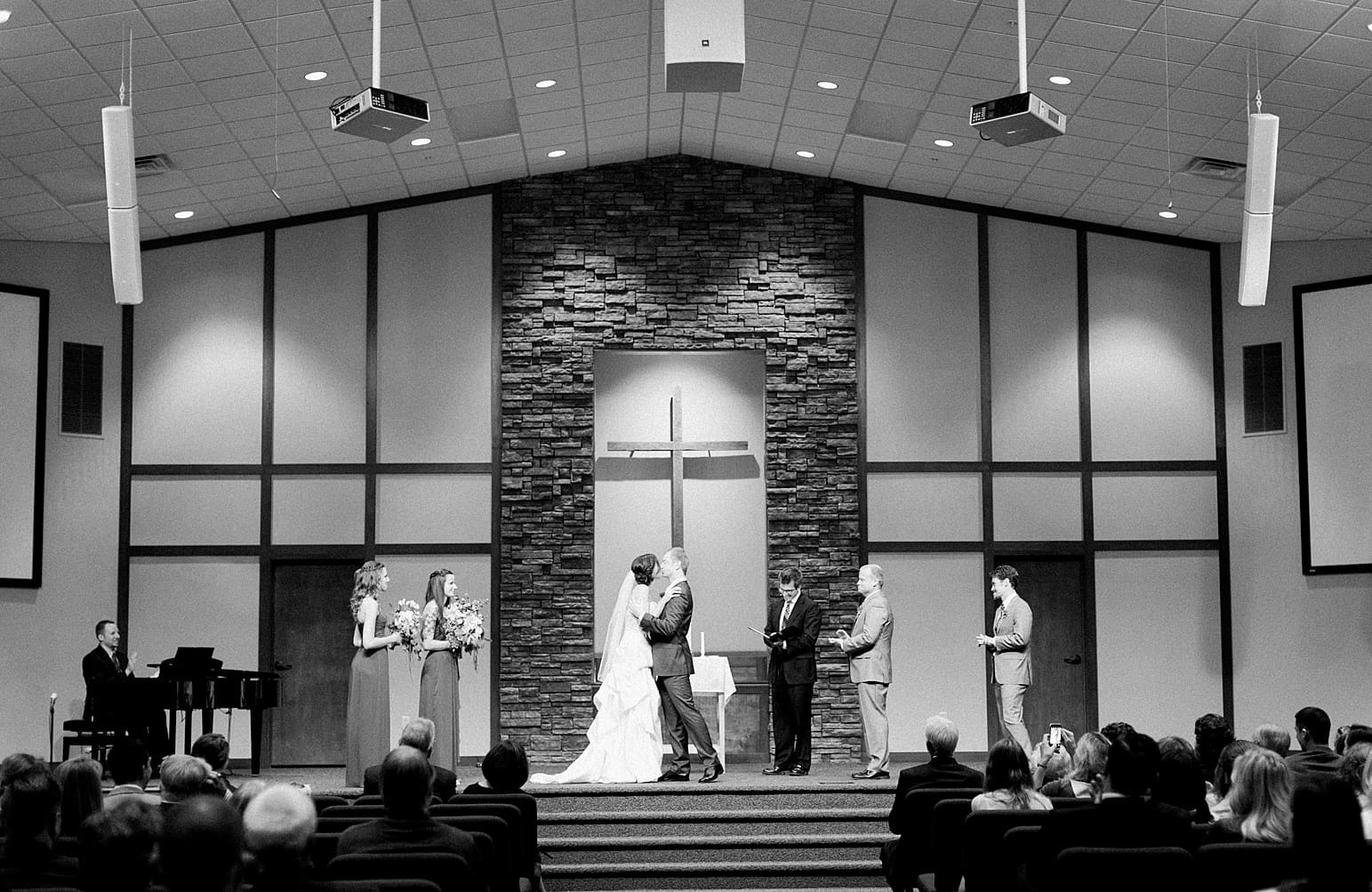 Arielle Peters Photography | Bride and groom kissing at the alter on fall wedding day in Winona Lake, Indiana.