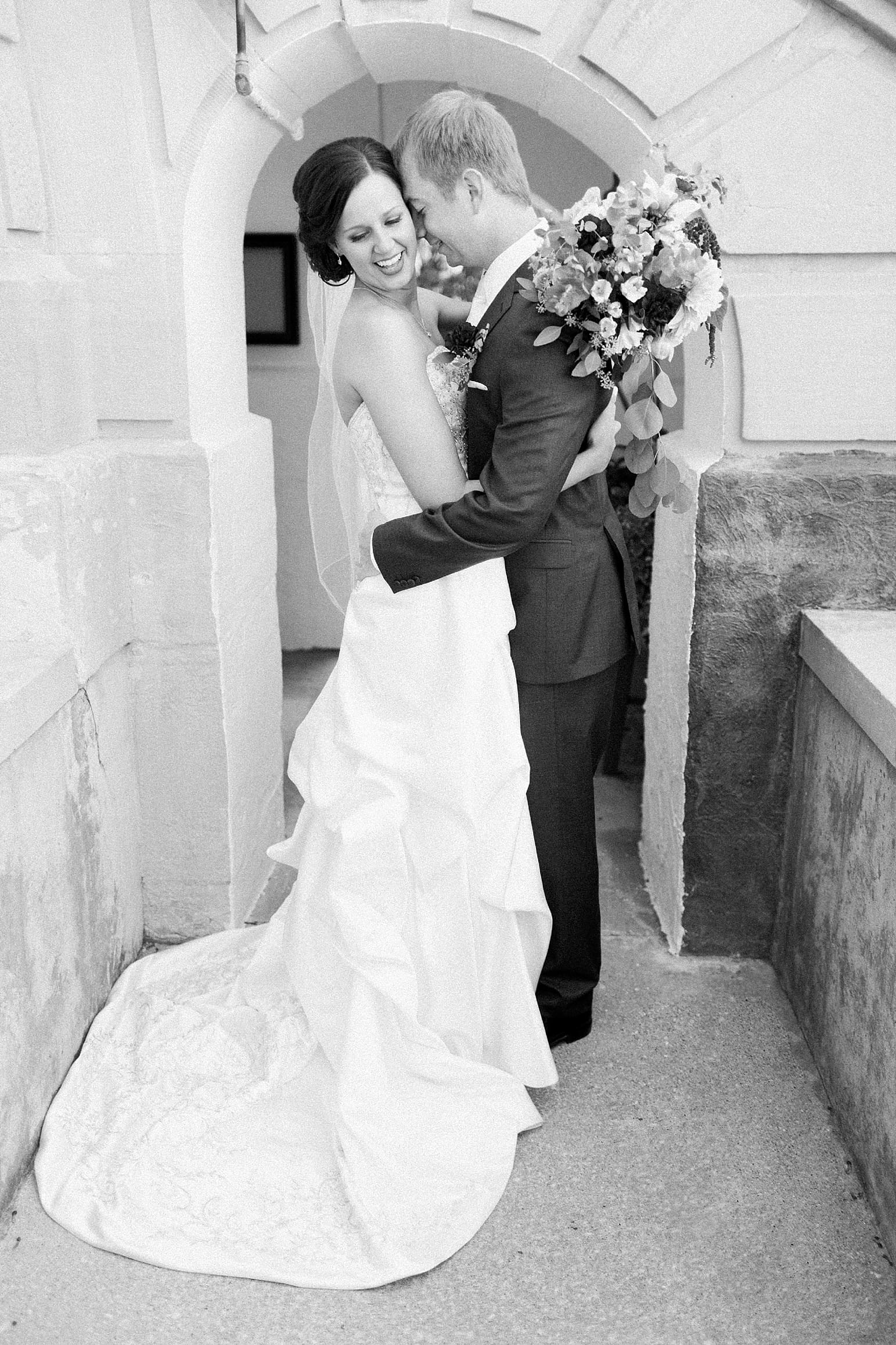 Arielle Peters Photography | Bride and groom outside limestone church on fall wedding day in Winona Lake, Indiana.