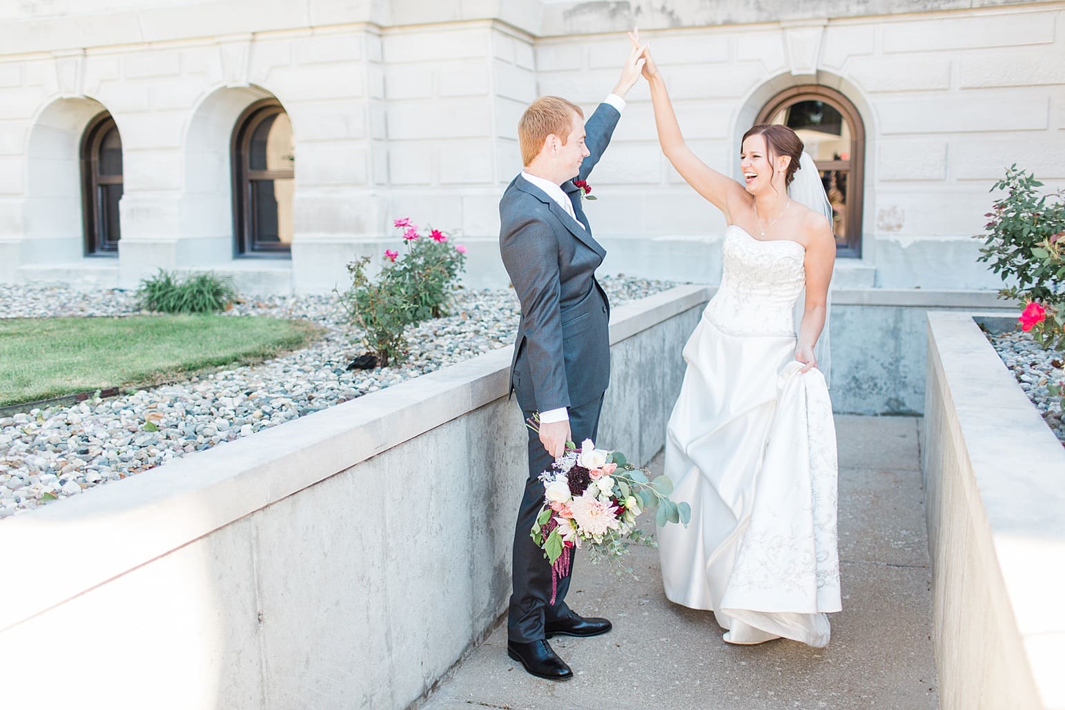 Arielle Peters Photography | Bride and groom dancing outside limestone church on fall wedding day in Winona Lake, Indiana.