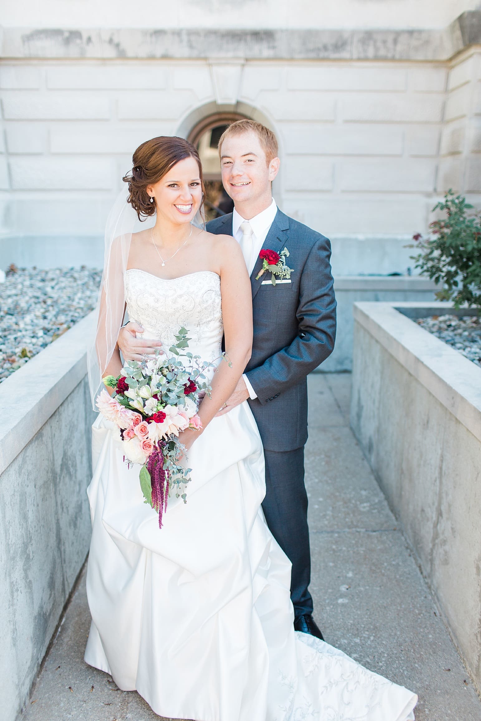 Arielle Peters Photography | Bride and groom almost outside limestone church on fall wedding day in Winona Lake, Indiana.