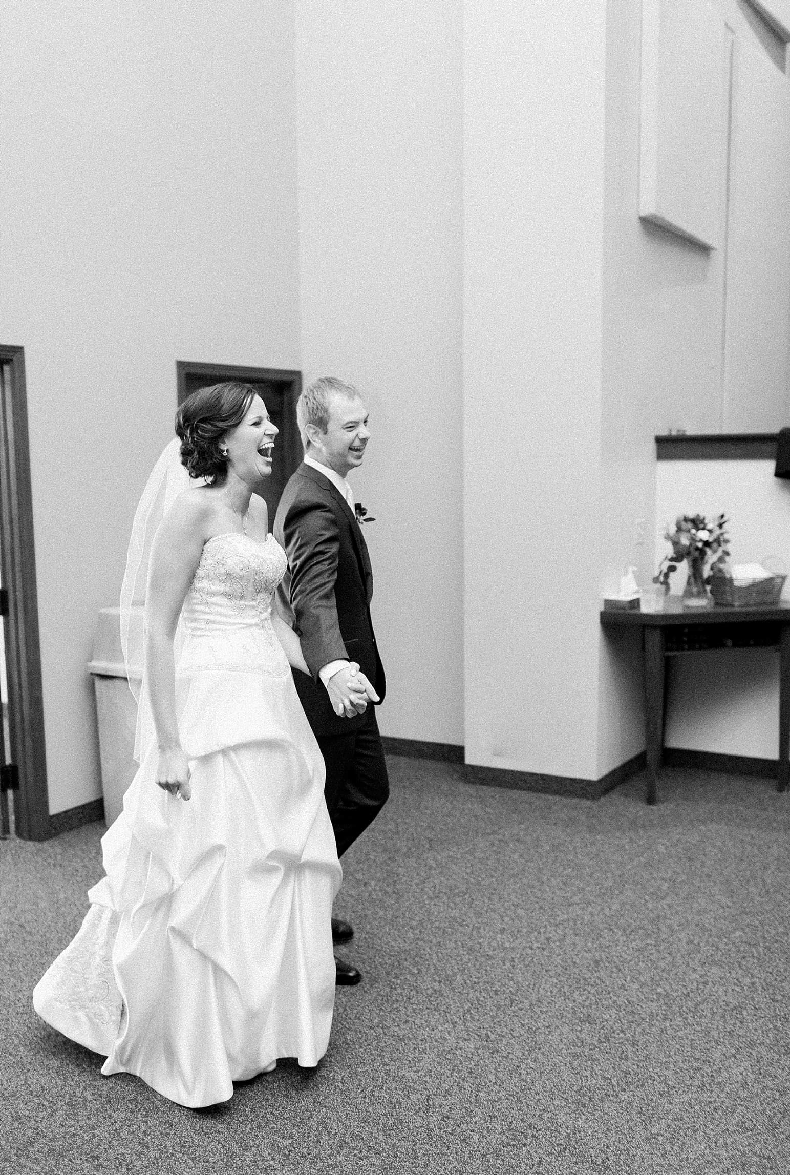 Arielle Peters Photography | Bride and groom entering wedding reception on fall wedding day in Winona Lake, Indiana.