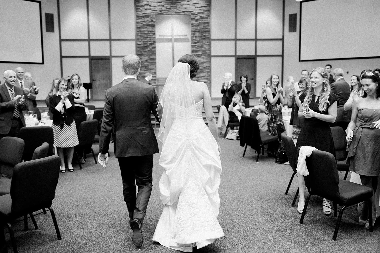 Arielle Peters Photography | Bride and groom entering wedding reception on fall wedding day in Winona Lake, Indiana.