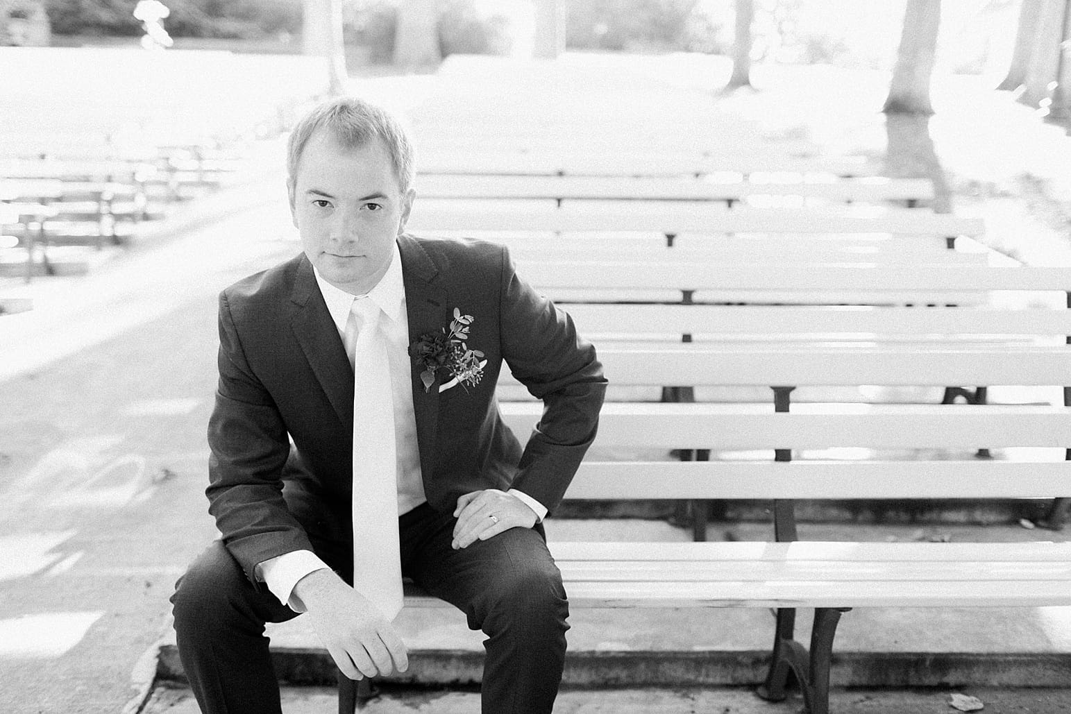 Arielle Peters Photography | Groom on bench in park on fall wedding day in Winona Lake, Indiana.