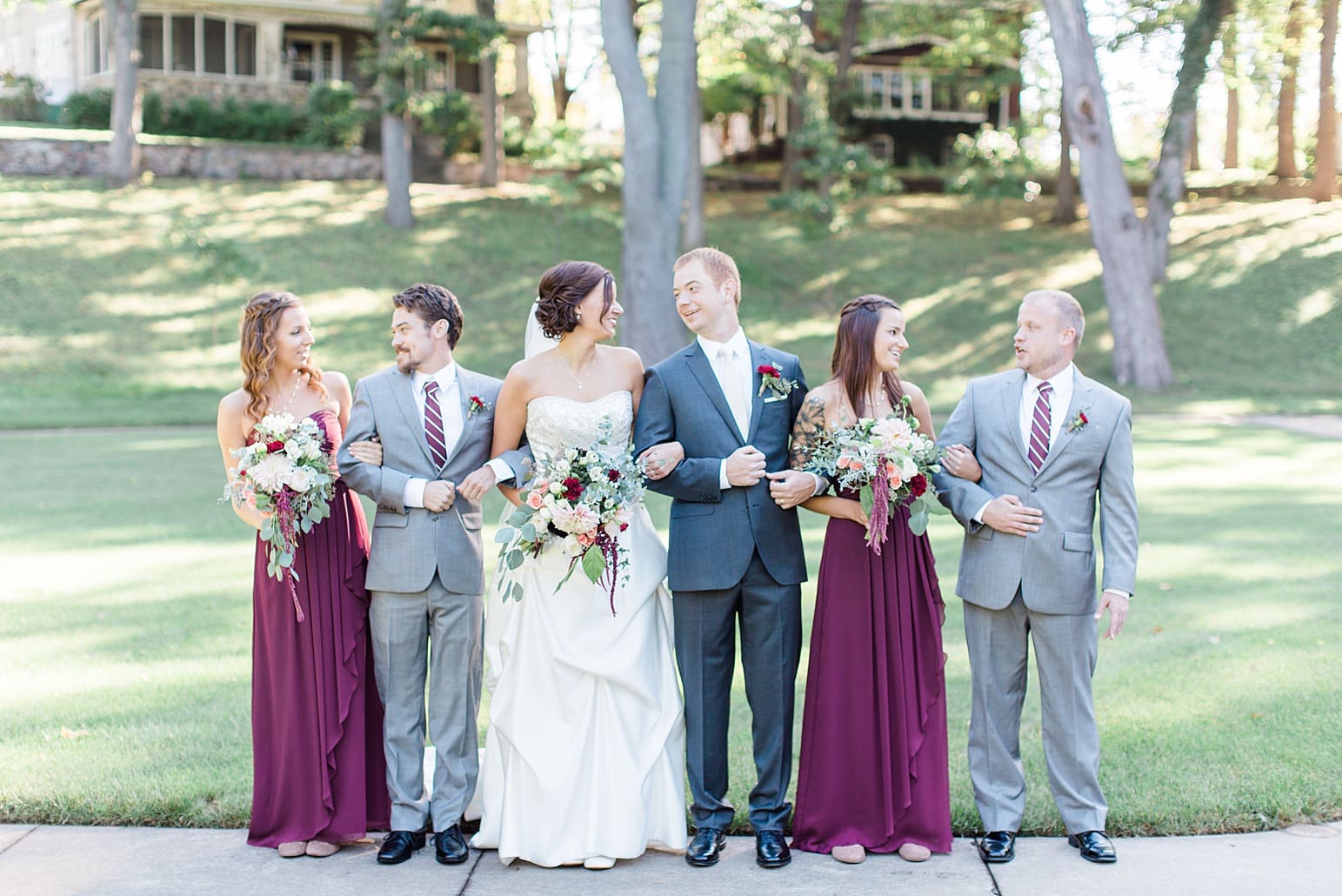 Arielle Peters Photography | Wedding party laughing in park on fall wedding day in Winona Lake, Indiana.