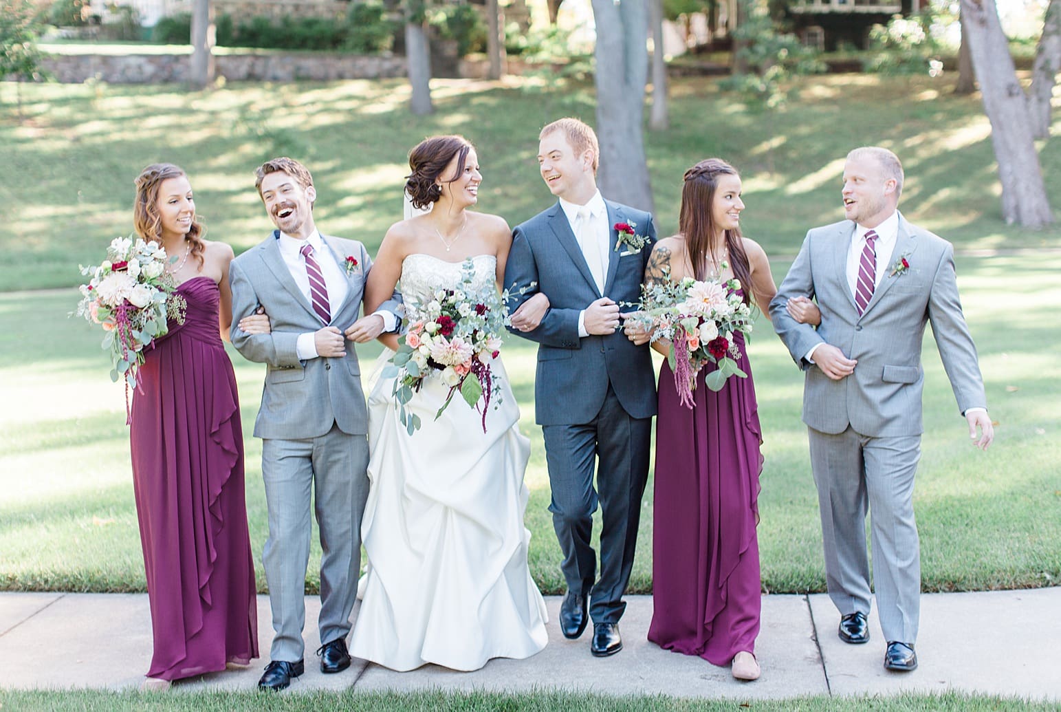 Arielle Peters Photography | Wedding party walking in park on fall wedding day in Winona Lake, Indiana.