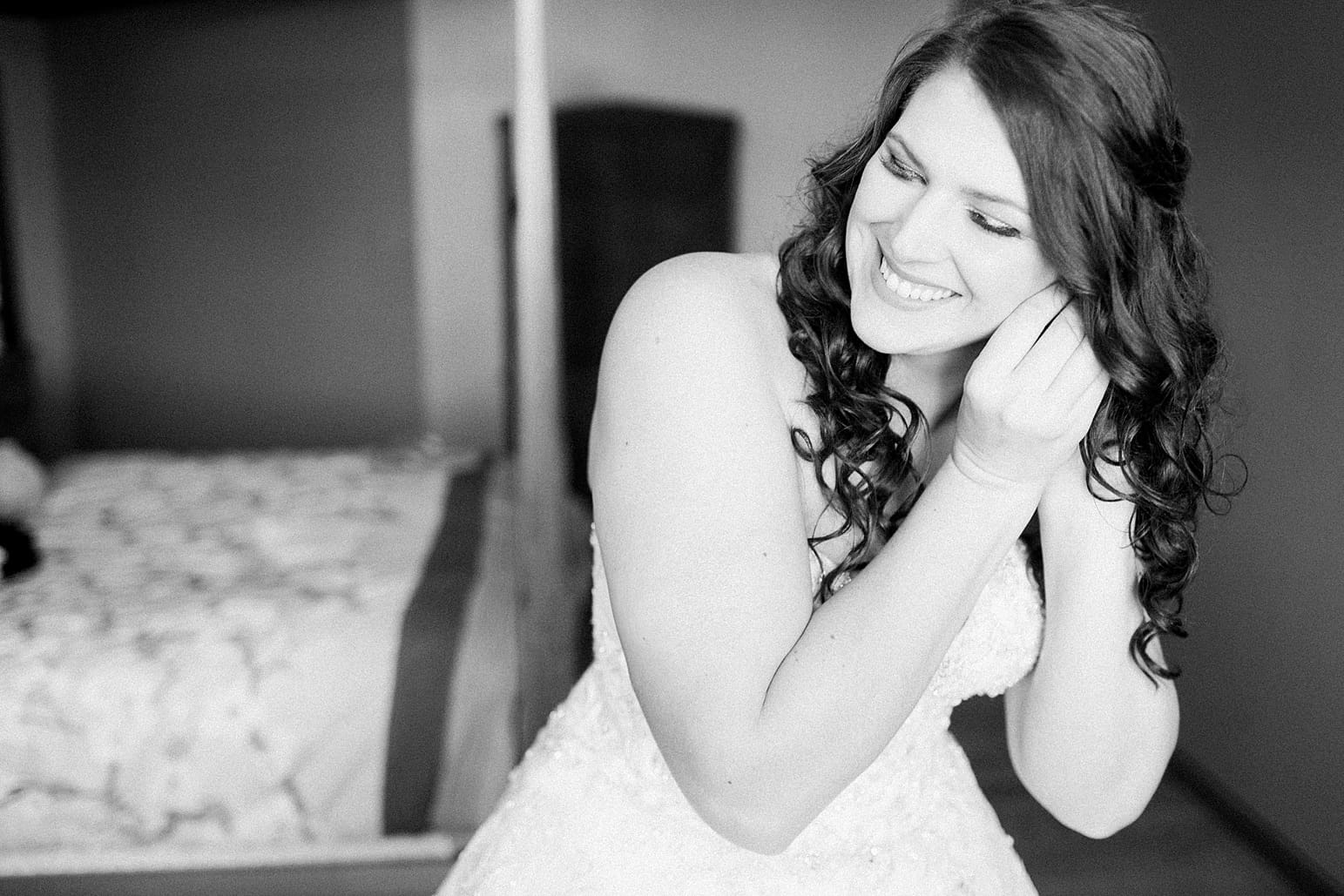 Arielle Peters Photography | Bride putting on wedding earrings on wedding day at the Ritz Charles Garden Pavilion in Carmel, Indiana. 