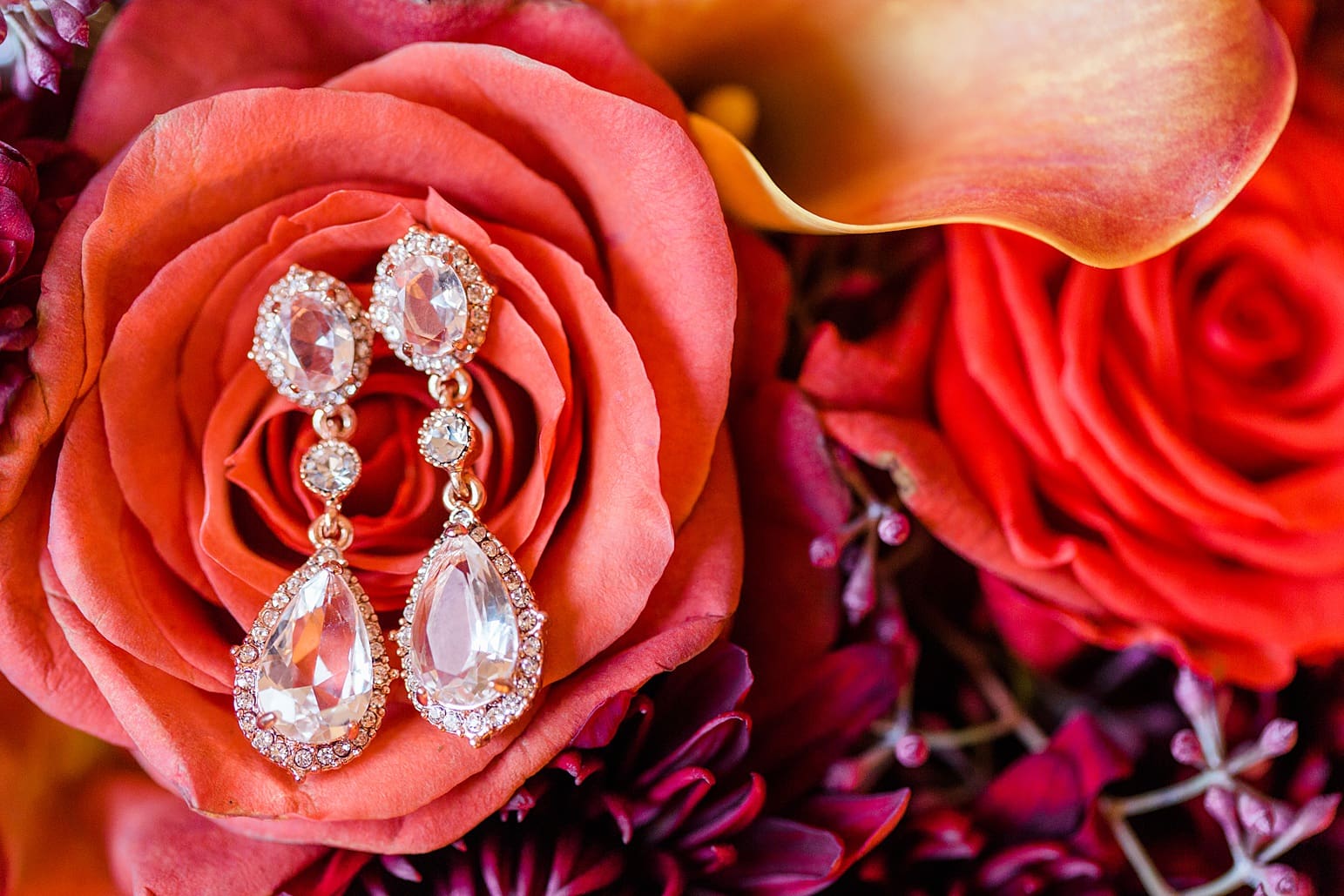 Arielle Peters Photography | Wedding earrings on orange roses on wedding day at the Ritz Charles Garden Pavilion in Carmel, Indiana. 