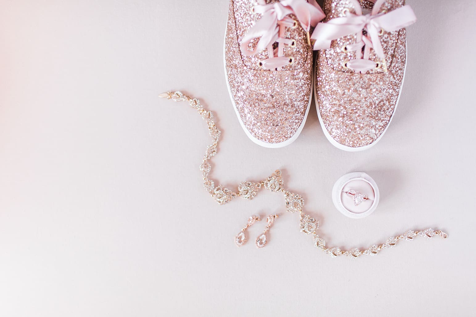 Arielle Peters Photography | Wedding shoes and jewelry on cream background on wedding day at the Ritz Charles Garden Pavilion in Carmel, Indiana. 