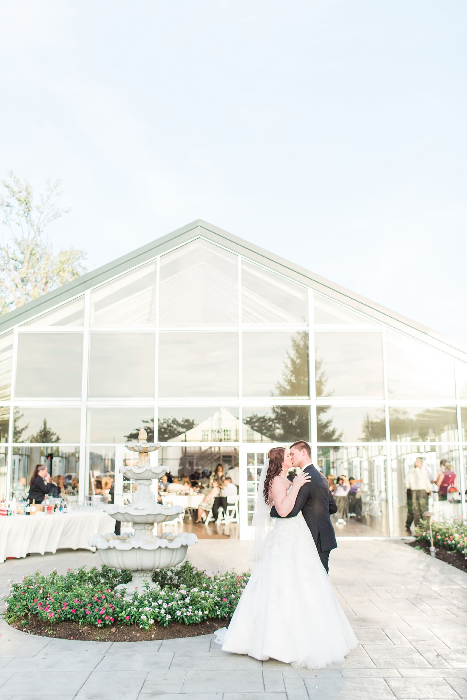 Arielle Peters Photography | Bride and groom kissing in courtyard outside on wedding day at the Ritz Charles Garden Pavilion in Carmel, Indiana. 