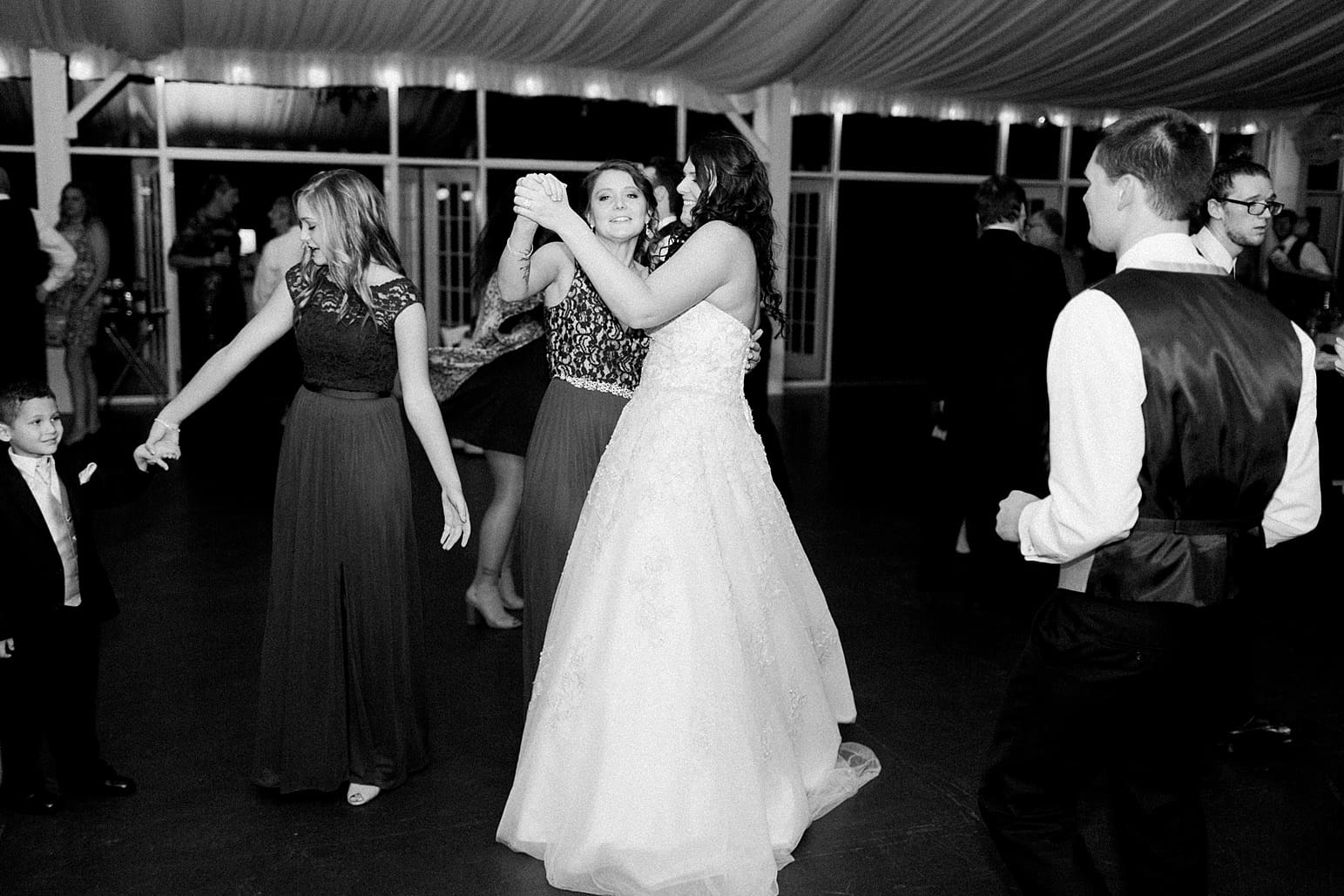 Arielle Peters Photography | Bride and groom dancing with guests at wedding reception on wedding day at the Ritz Charles Garden Pavilion in Carmel, Indiana. 