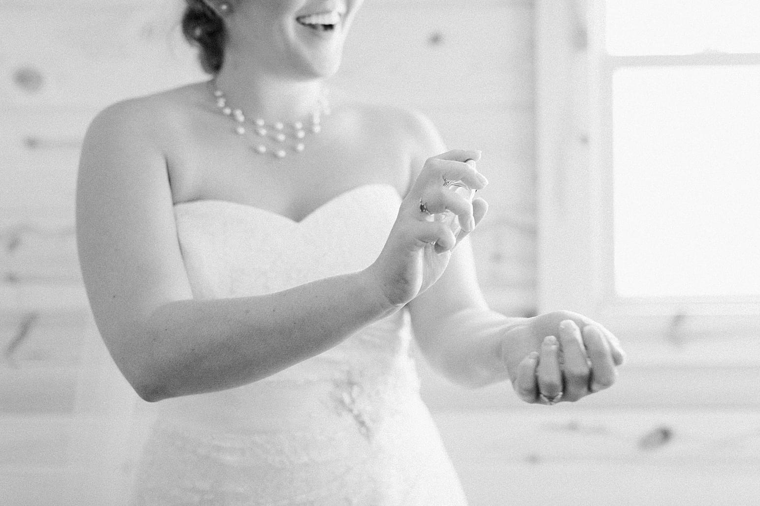 Arielle Peters Photography | Bride putting on perfume on wedding day in Syracuse, Indiana.