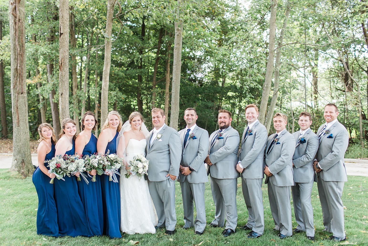 Arielle Peters Photography | Wedding party outside under trees on wedding day in Syracuse, Indiana.
