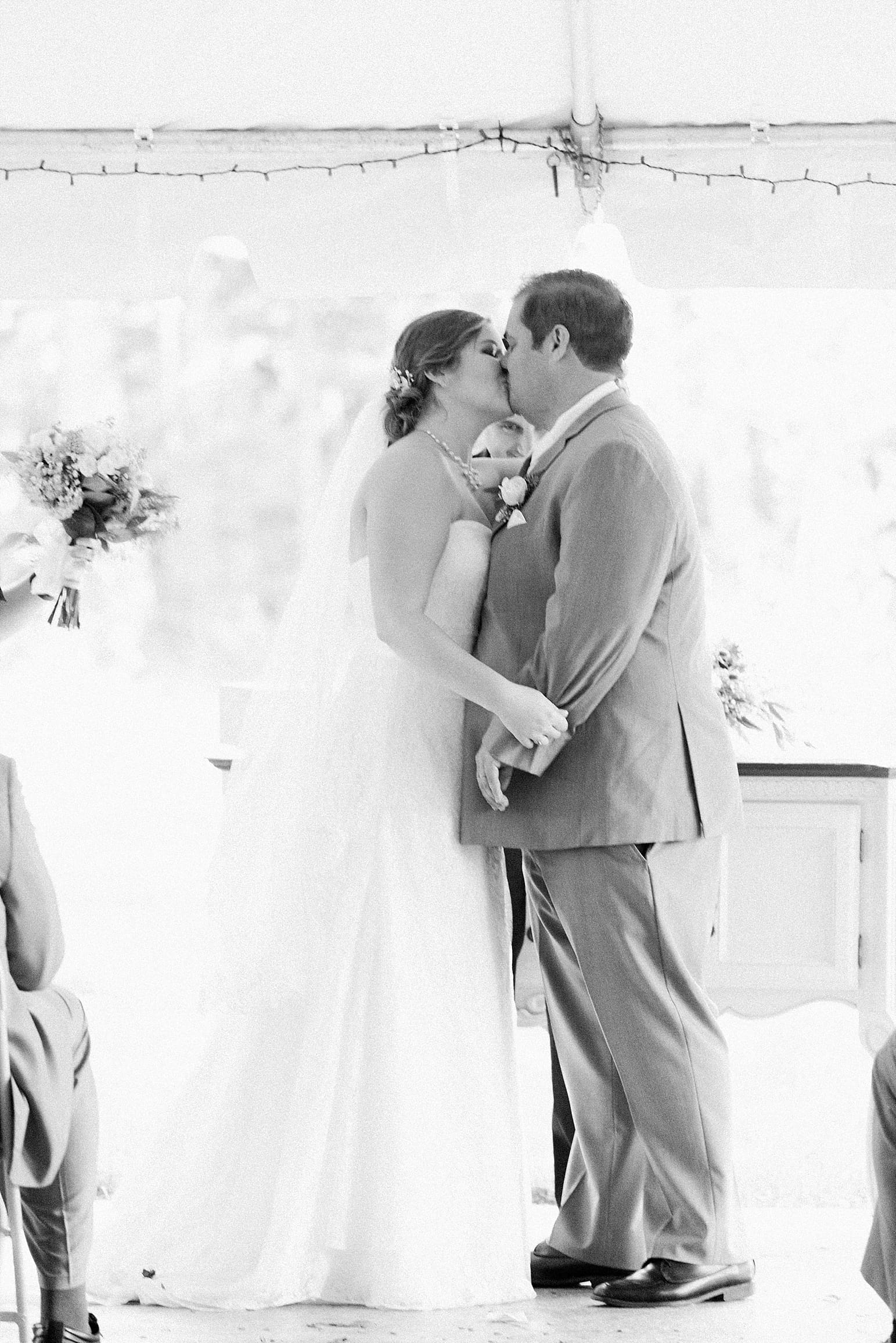 Arielle Peters Photography | Bride and groom kissing at the alter on wedding day in Syracuse, Indiana.