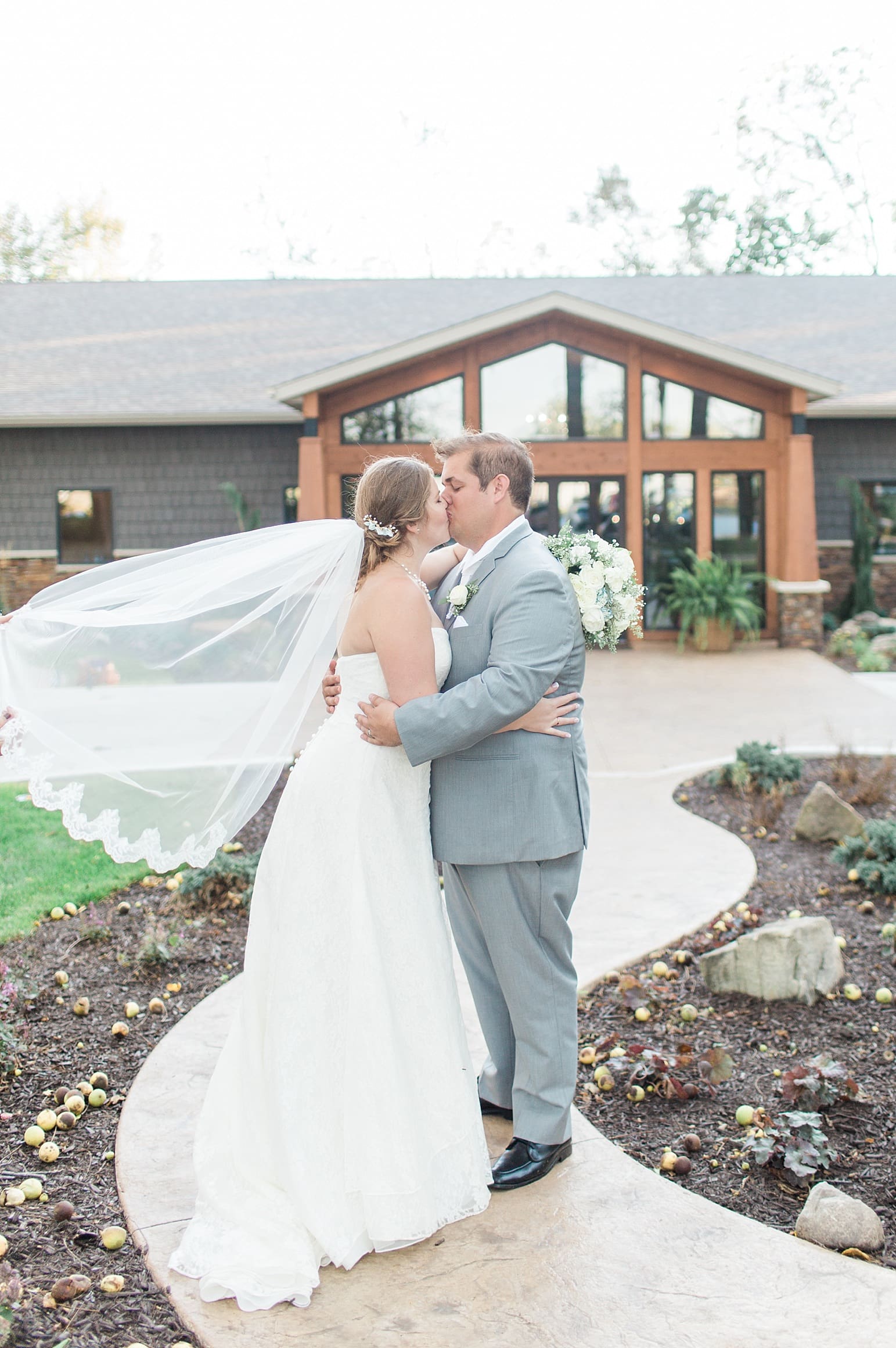 Arielle Peters Photography | Bride and groom kissing outside on fall wedding day in Syracuse, Indiana.
