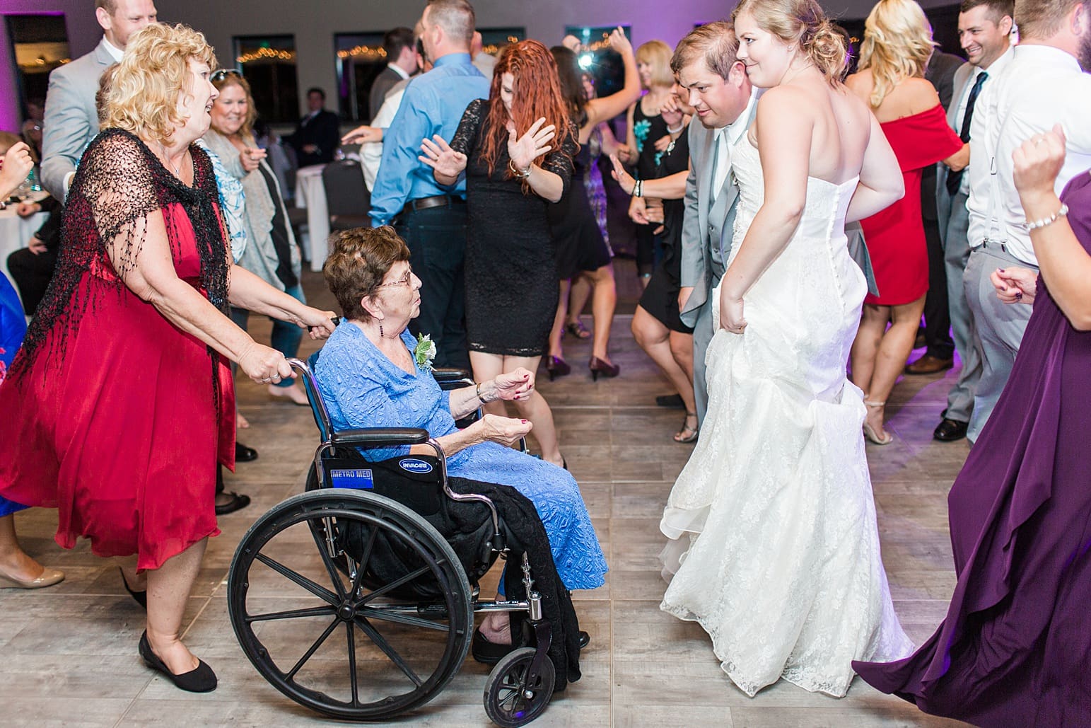 Arielle Peters Photography | Bride and groom dancing with guests on wedding day at Sleepy Owl Restaurant in Syracuse, Indiana.