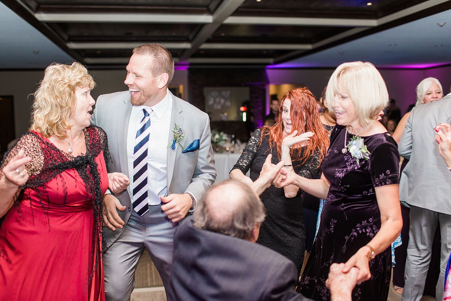 Arielle Peters Photography | Wedding guests dancing on wedding day at Sleepy Owl Restaurant in Syracuse, Indiana.
