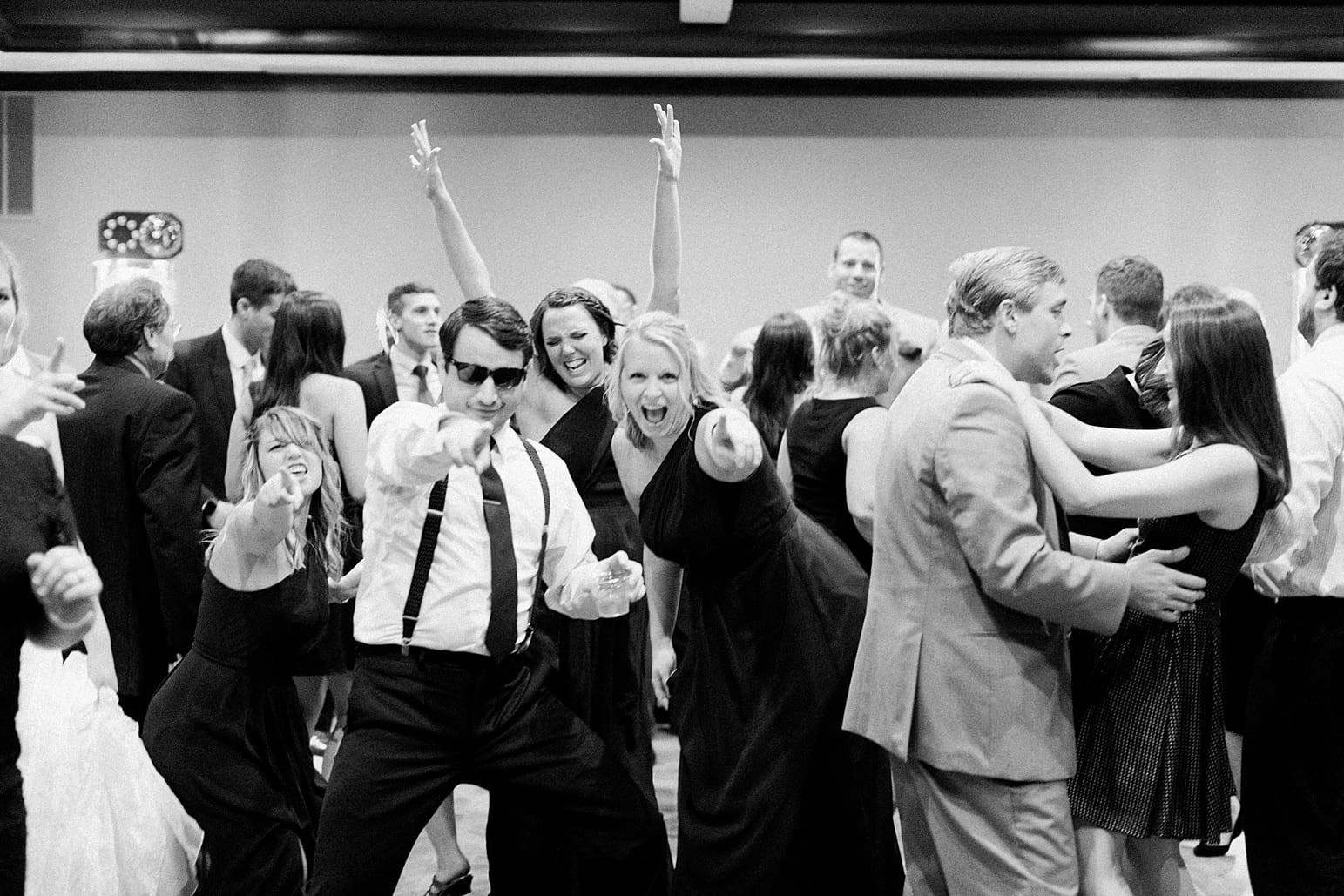 Arielle Peters Photography | Wedding guests dancing on wedding day at Sleepy Owl Restaurant in Syracuse, Indiana.